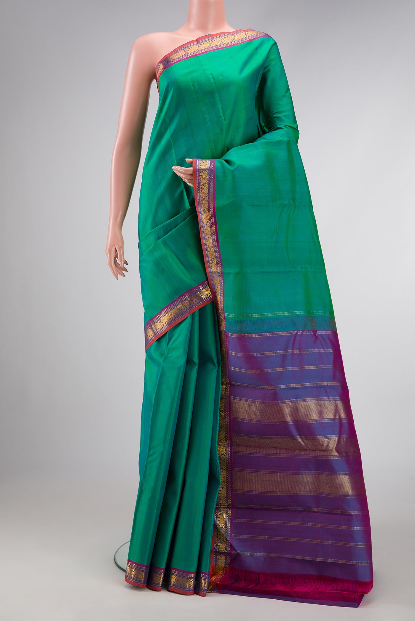 Pure Silk Pure Zari Green Dual Tone Kanchipuram Saree with Plain Body and Zari Border.  displayed on a mannequin