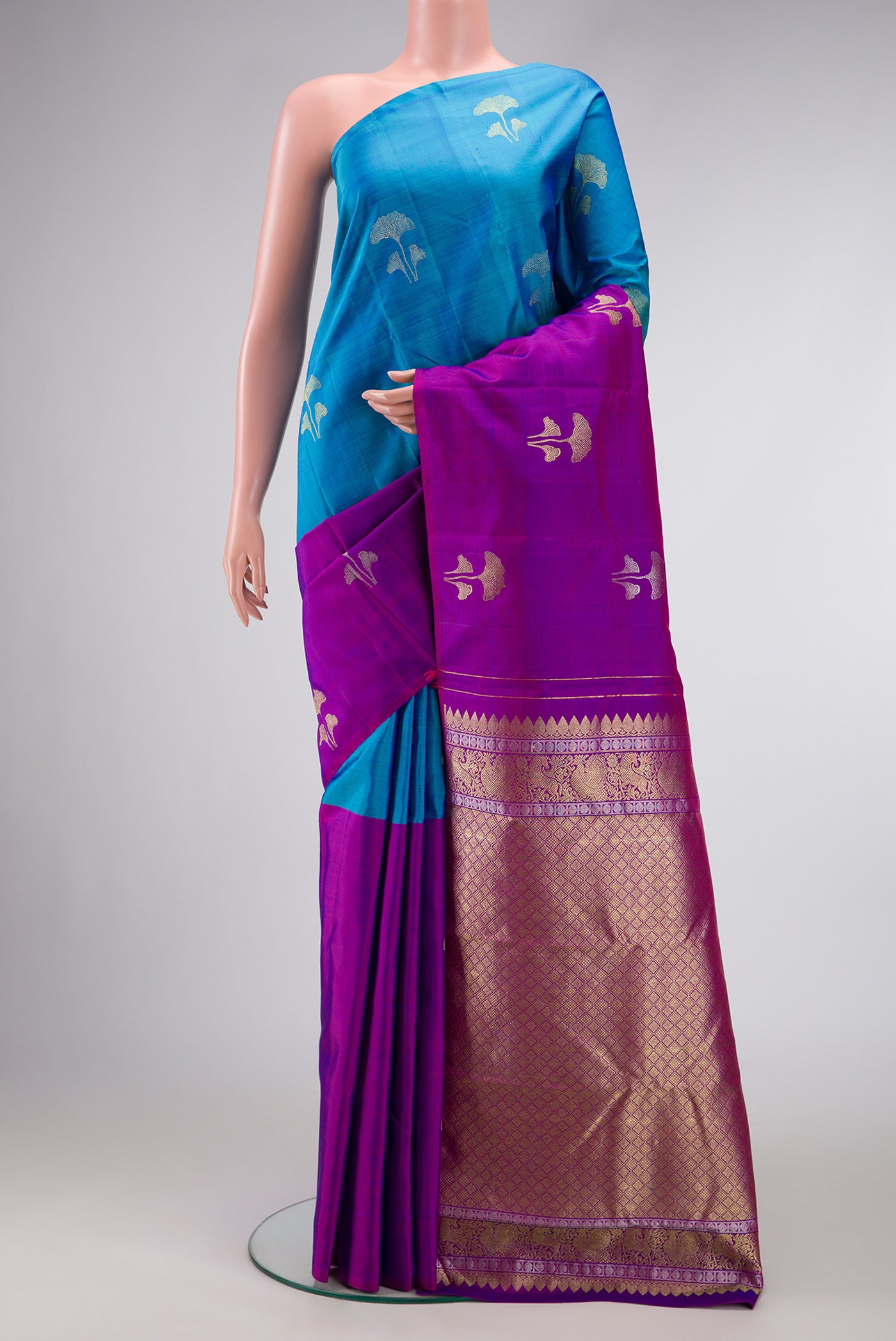 Peacock Blue and Purple Color Kanchipuram Silk Saree with Half And Half on the body and Without Border.  displayed on a mannequin