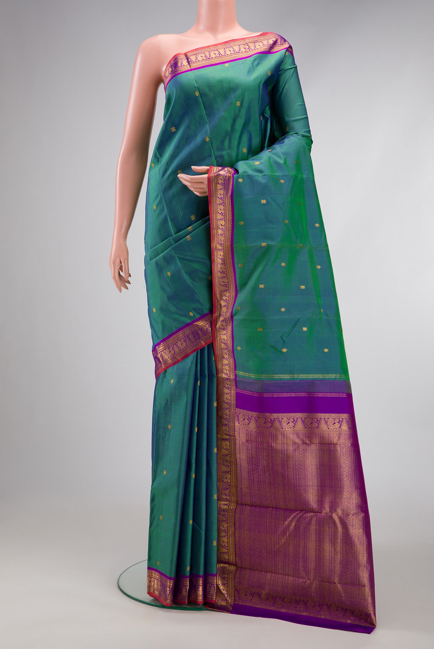 Peacock Blue Dual Tone Kanchipuram Silk Saree with Zari Butta on the body and Zari Border.  displayed on a mannequin