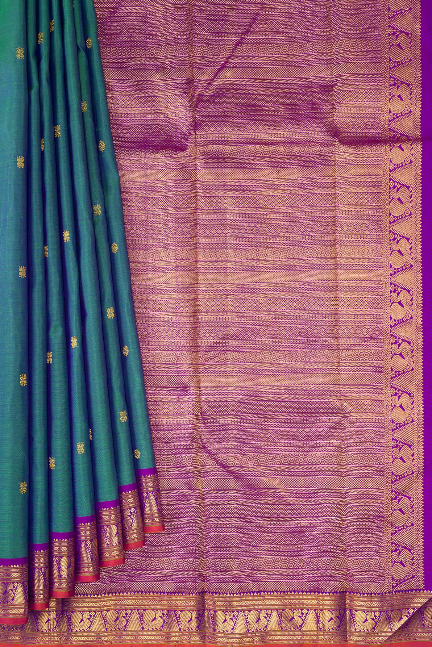Pleats and pallu of Peacock Blue Dual Tone Kanchipuram Silk Saree with Zari Butta on the body and Zari Border. 