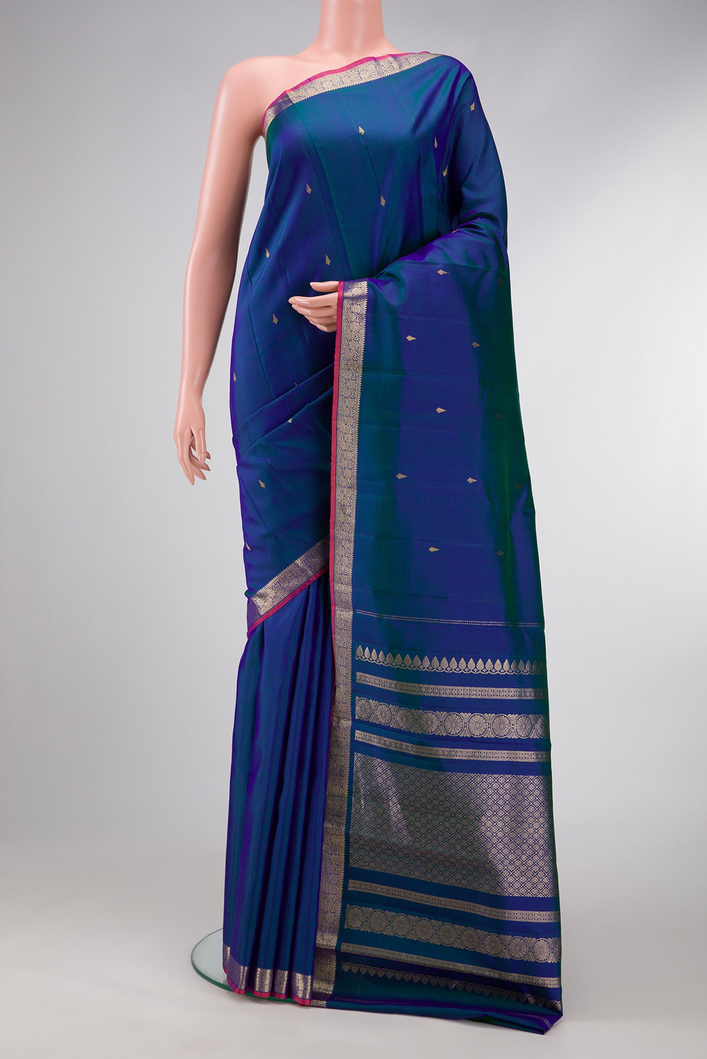 Peacock Blue Dual Tone Kanchipuram Silk Saree with Zari Butta on the body and Zari Border.  displayed on a mannequin