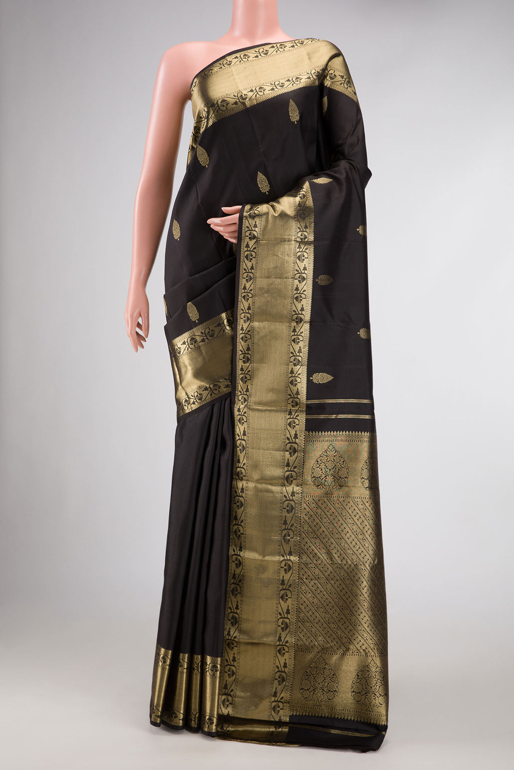 Black Dual Tone Kanchipuram Silk Saree with Zari Butta on the body and Zari Border.  displayed on a mannequin
