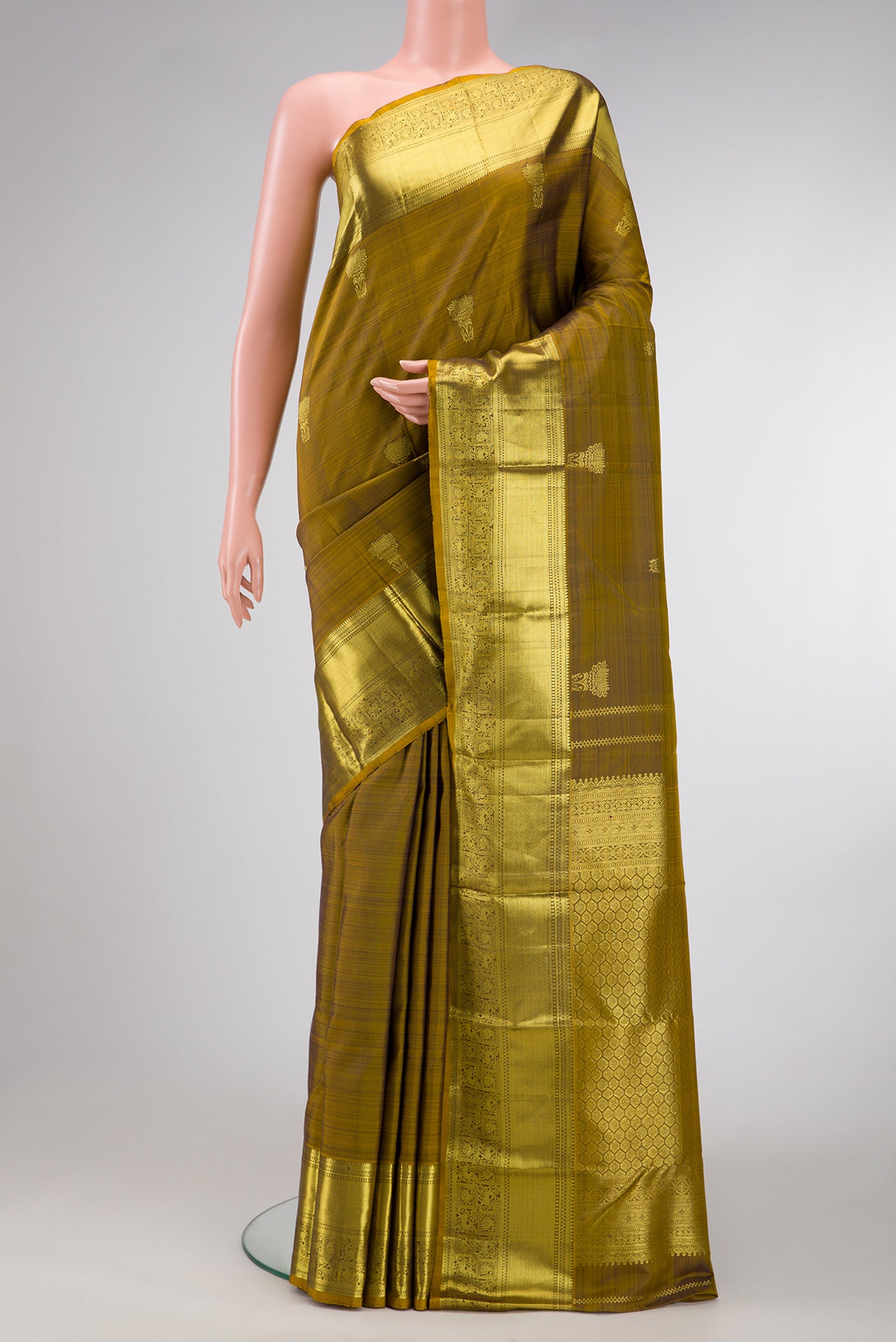 Mehandi Green Dual Tone Kanchipuram Silk Saree with Zari Butta on the body and Zari Border.  displayed on a mannequin