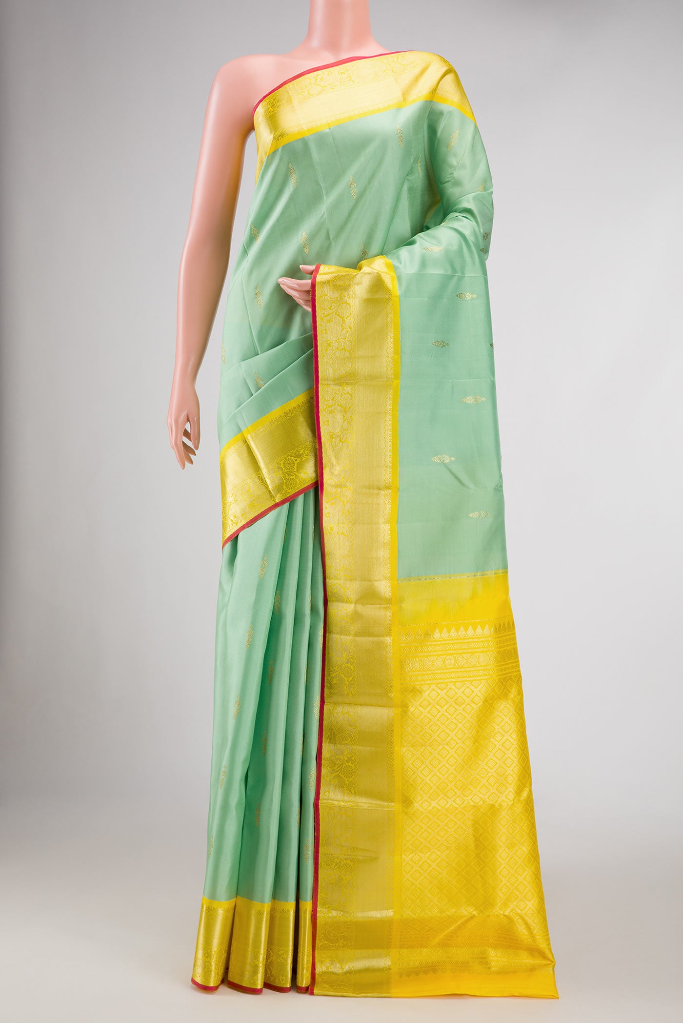 Pista Green Dual Tone Kanjivaram Silk Saree with Zari Butta on the body and Zari Border.  displayed on a mannequin