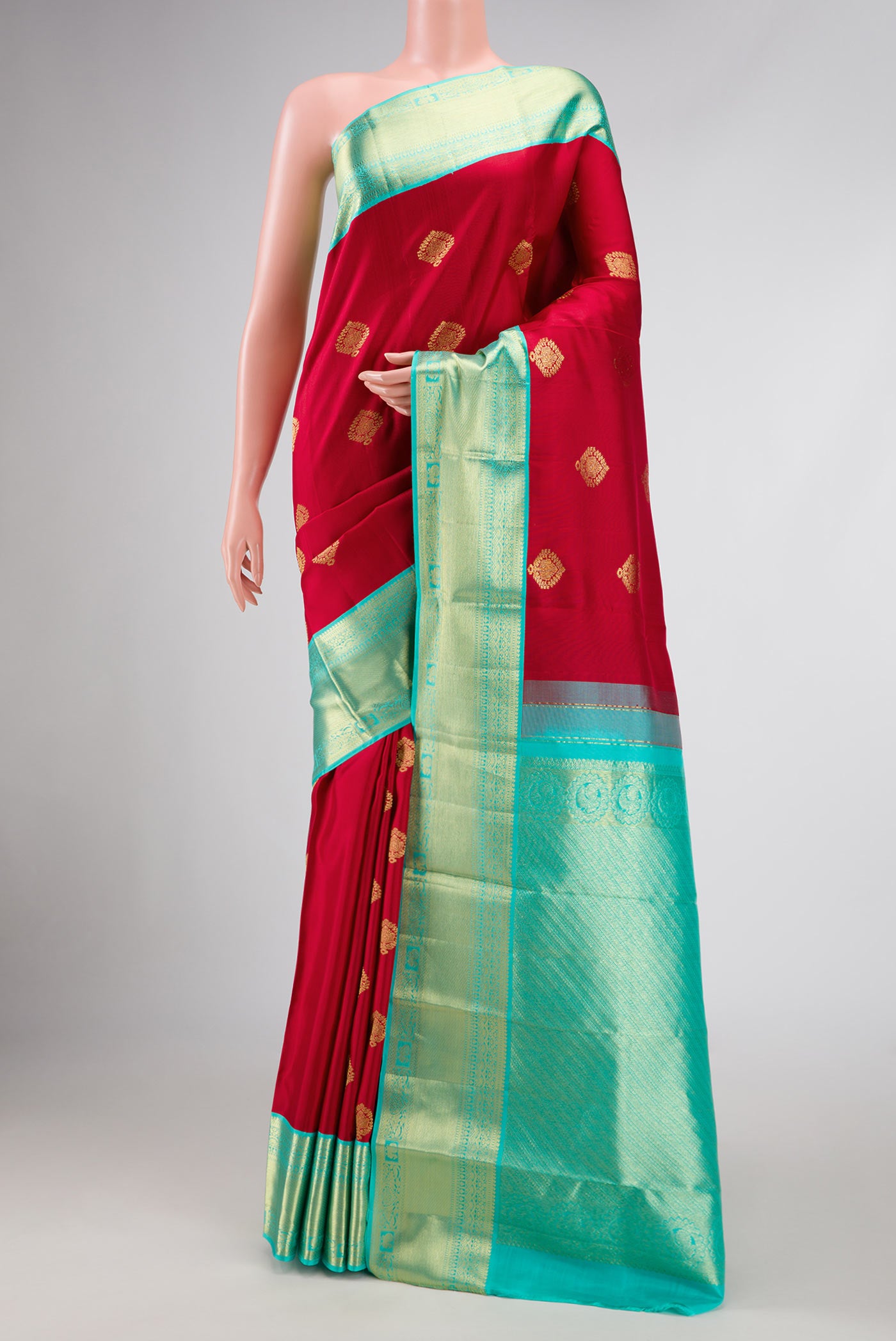 Red Dual Tone Kanjivaram Silk Saree with Zari Butta on the body and Zari Border.  displayed on a mannequin