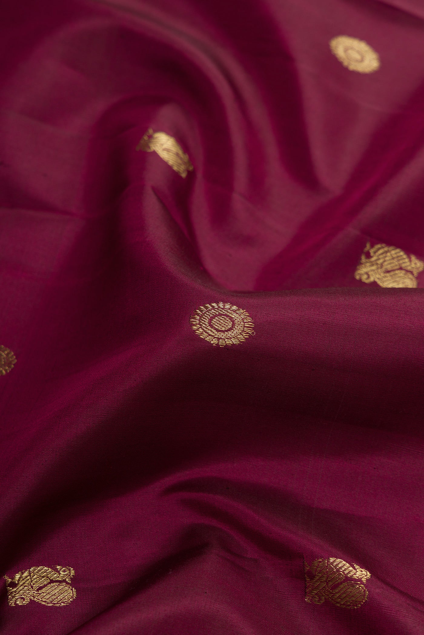 Close up of Coffee Brown Dual Tone Kanjivaram Silk Saree with Zari Butta on the body and Zari Border.  displaying folds