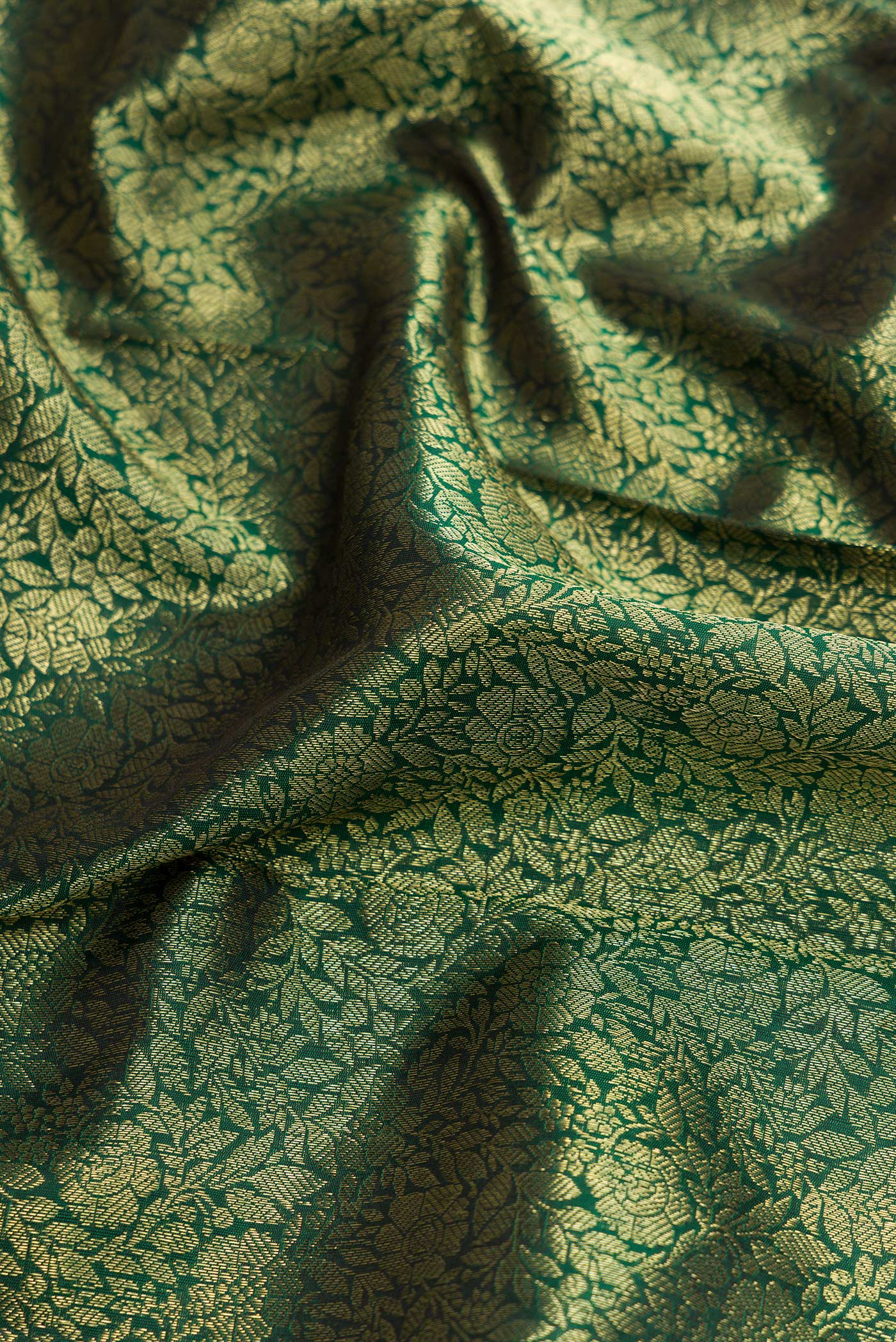Close up of Bottle Green Dual Tone Kanchipuram Silk Saree with Zari Brocade on the body and Zari Border.  displaying folds