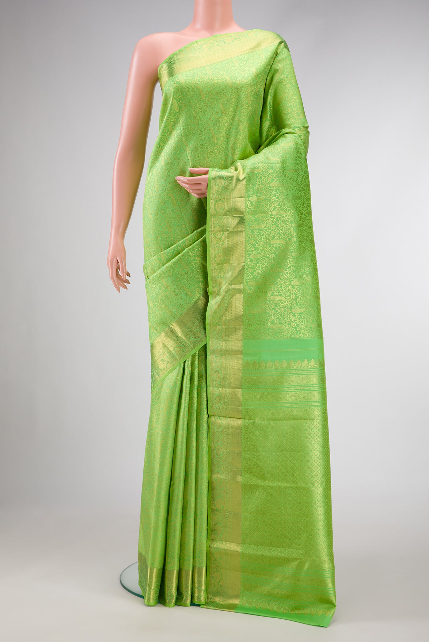 Parrot Green Dual Tone Kanchipuram Silk Saree with Zari Brocade on the body and Zari Border.  displayed on a mannequin