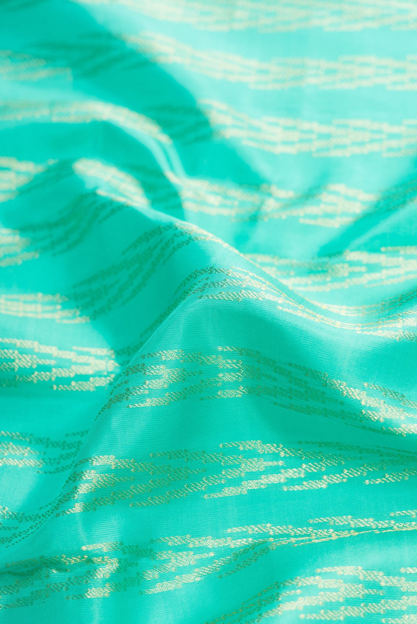 Close up of Sea Green Dual Tone Kanchipuram Silk Saree with Zari Brocade on the body and Zari Border.  displaying folds