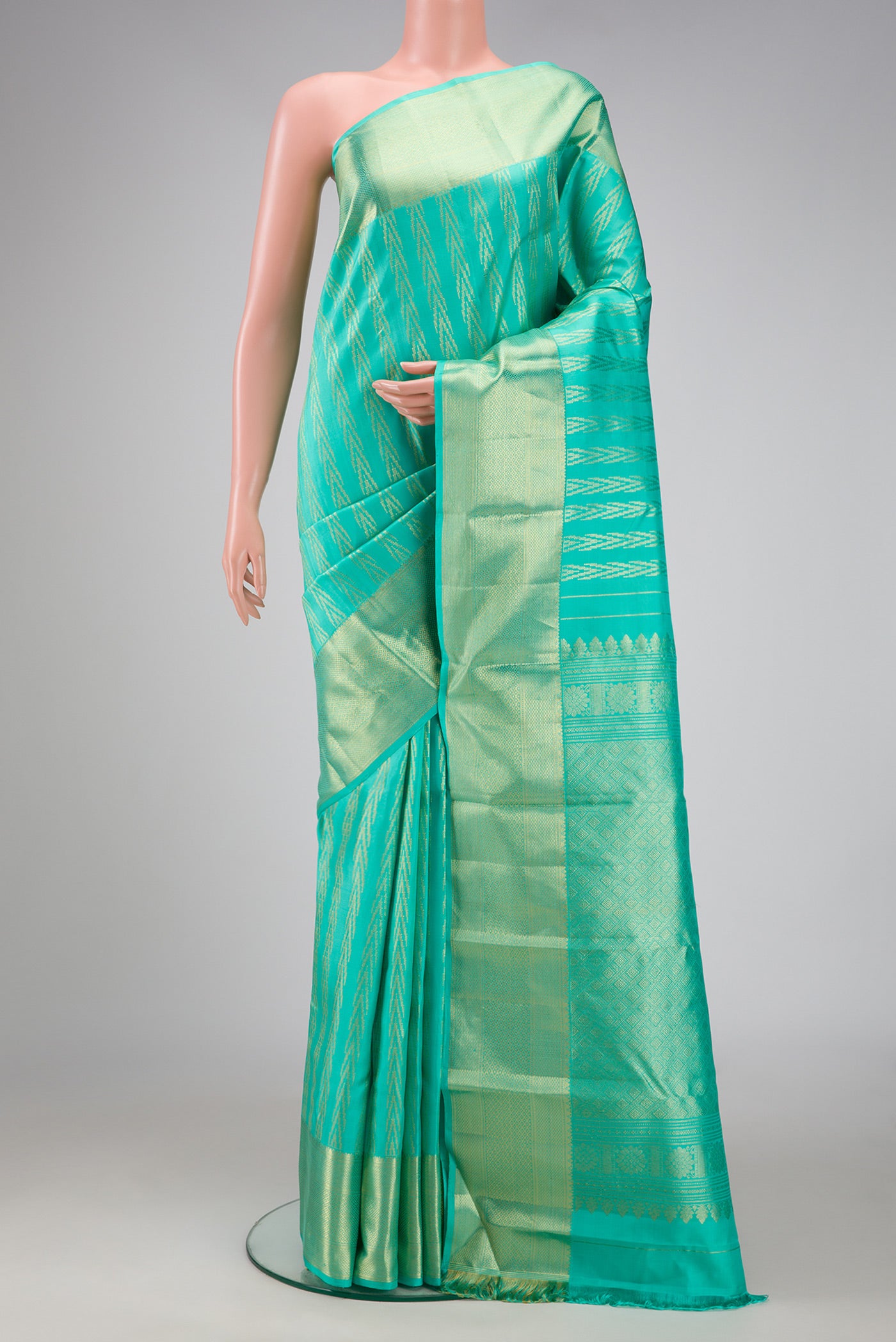 Sea Green Dual Tone Kanchipuram Silk Saree with Zari Brocade on the body and Zari Border.  displayed on a mannequin