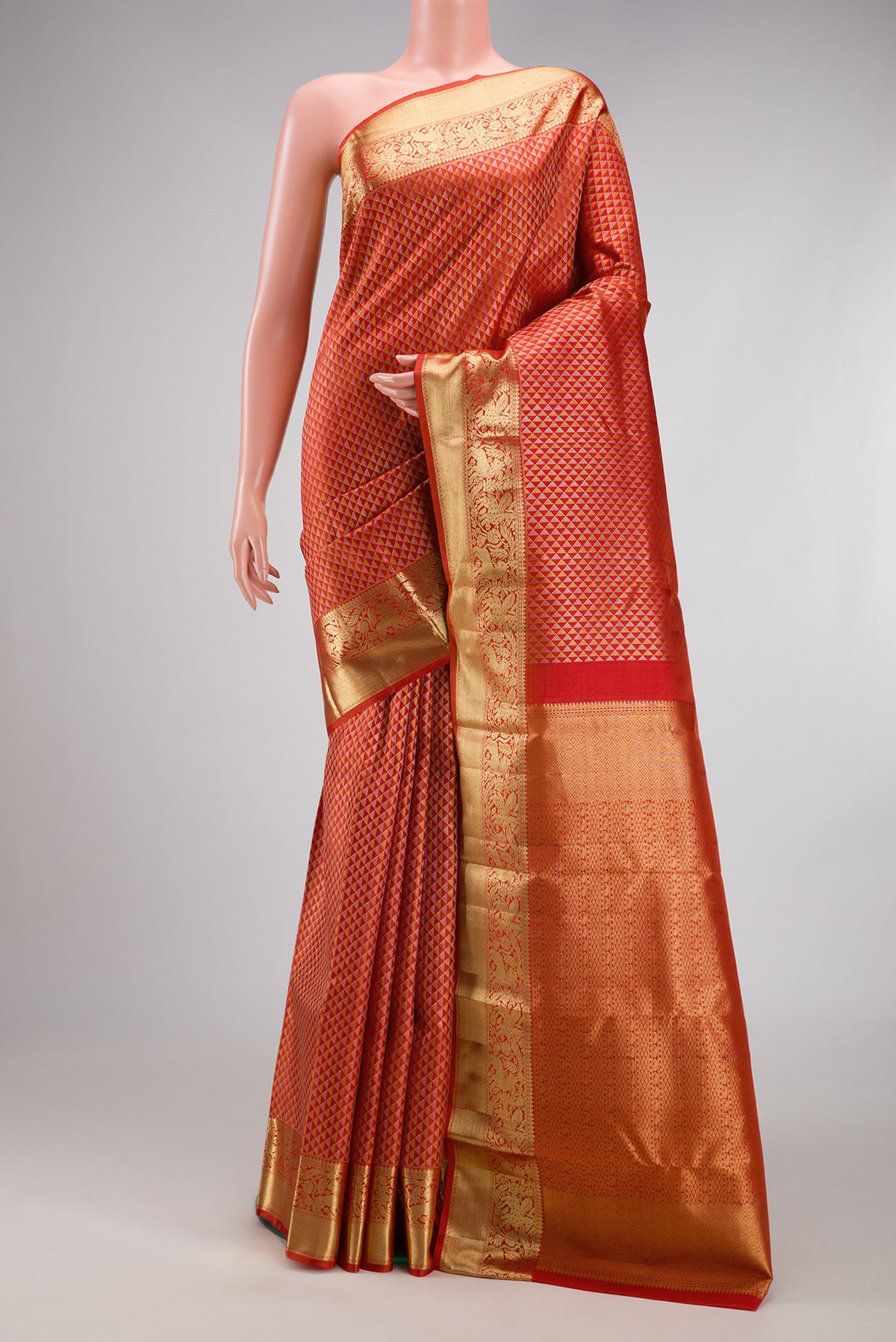 Orange Kanjivaram Silk Saree with Zari Brocade on the body and Zari Border.  displayed on a mannequin