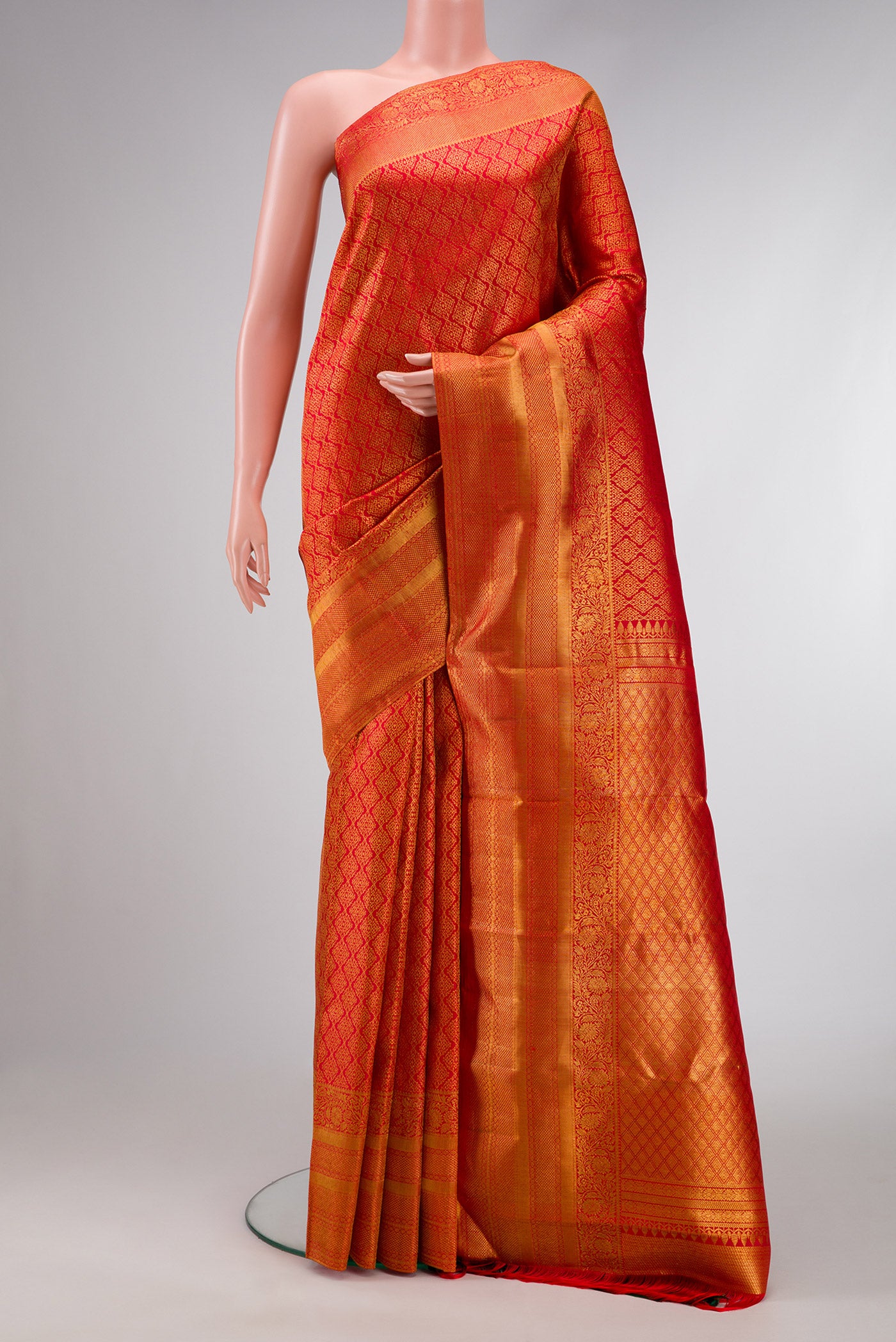 Red Dual Tone Kanjivaram Silk Saree with Zari Brocade on the body and Fancy Border.  displayed on a mannequin