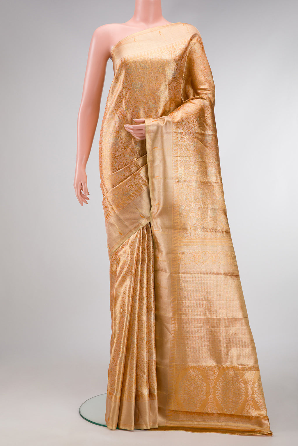 Golden Peach Dual Tone Kanjivaram Tissue Silk Saree with Zari Brocade on the body and Zari Border.  displayed on a mannequin