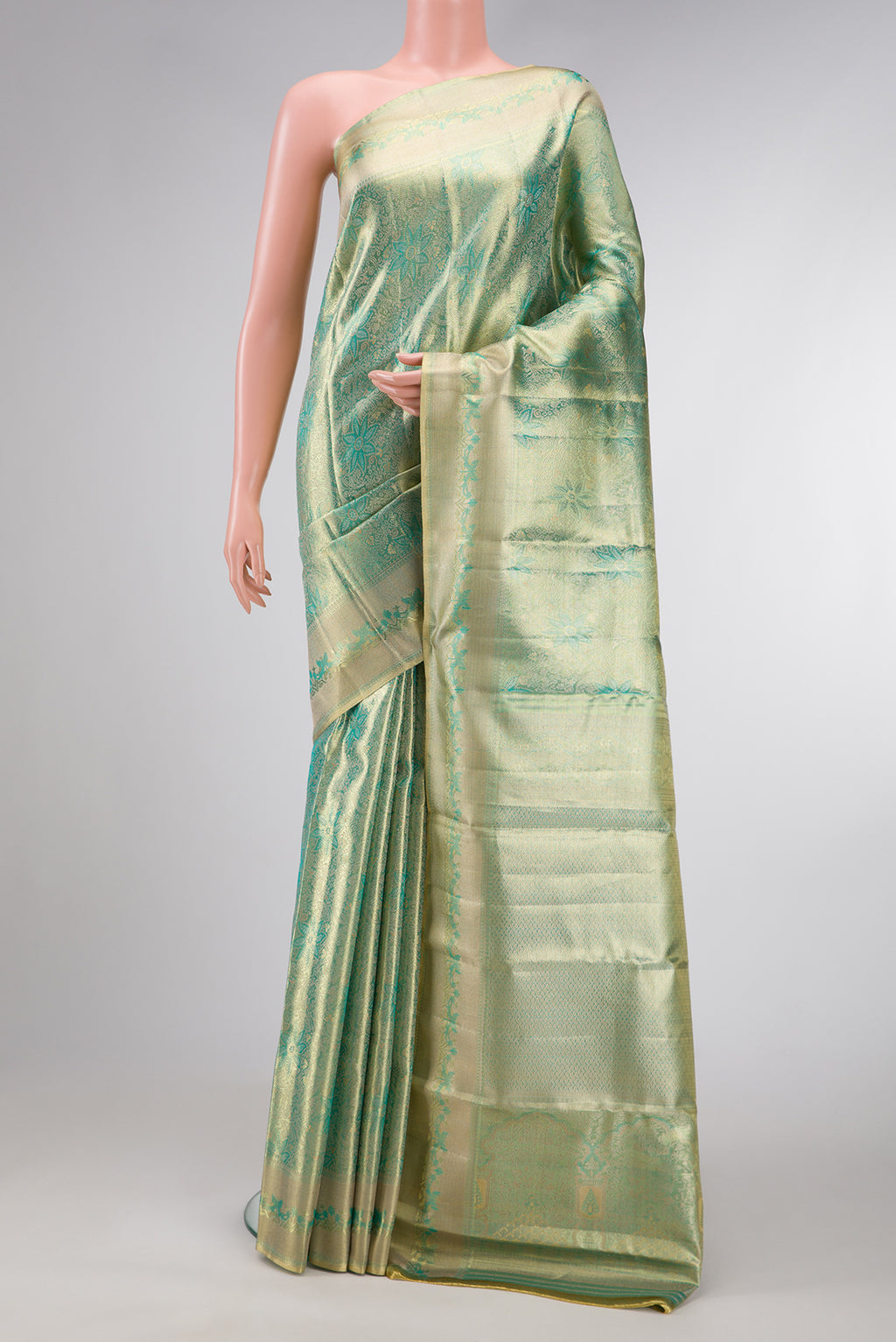 Green Dual Tone Kanjivaram Tissue Silk Saree with Zari Brocade on the body and Zari Border.  displayed on a mannequin