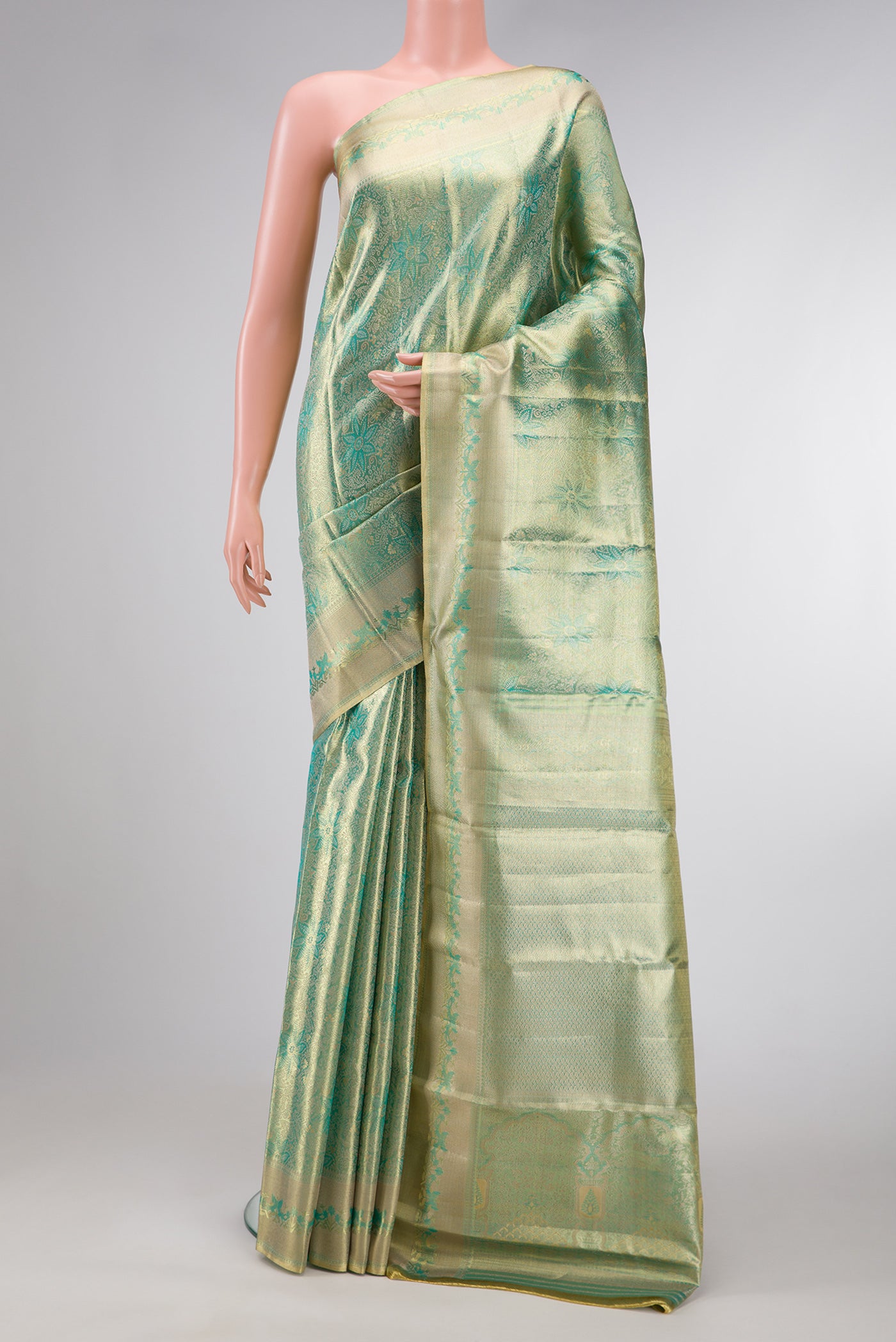 Green Dual Tone Kanjivaram Tissue Silk Saree with Zari Brocade on the body and Zari Border.  displayed on a mannequin