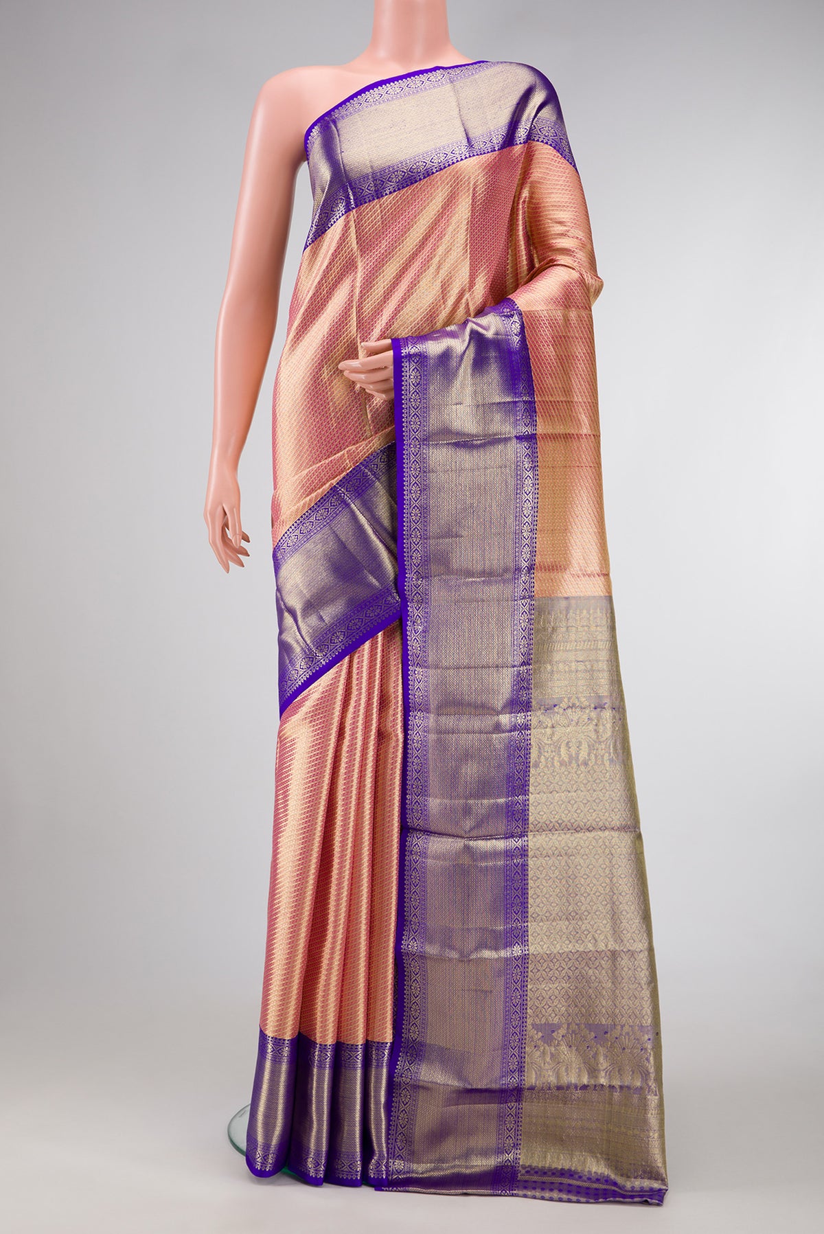 Golden Peach Dual Tone Kanjivaram Tissue Silk Saree with Zari Brocade on the body and Zari Border.  displayed on a mannequin