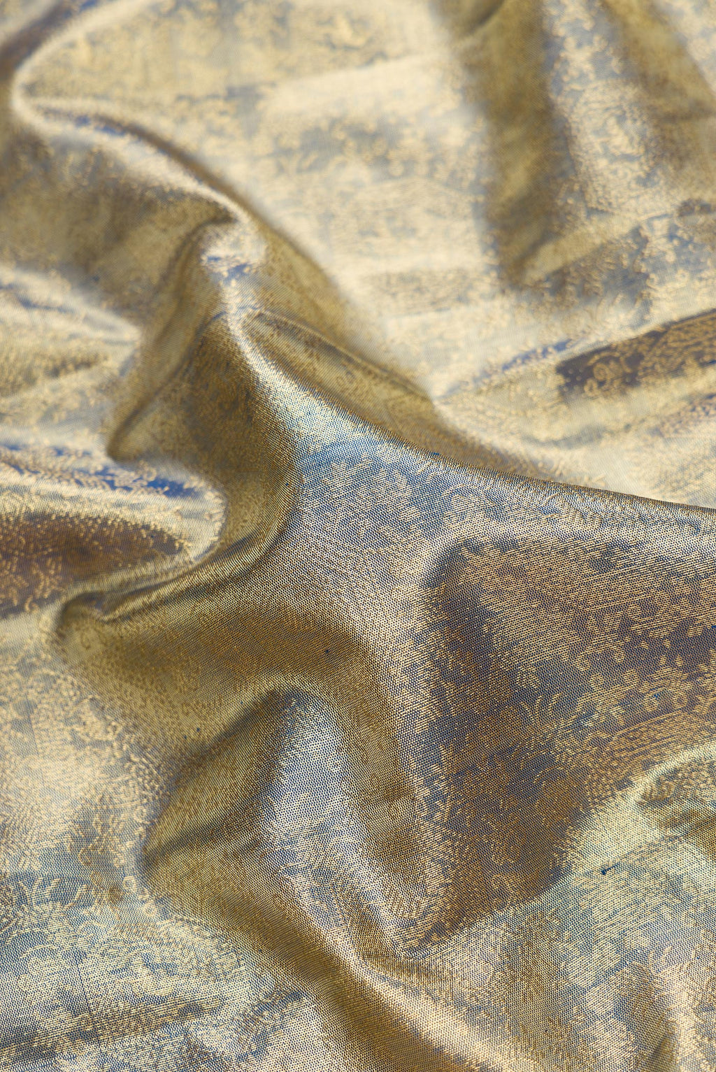 Close up of Green Dual Tone Kanjivaram Tissue Silk Saree with Zari Brocade on the body and Zari Border.  displaying folds