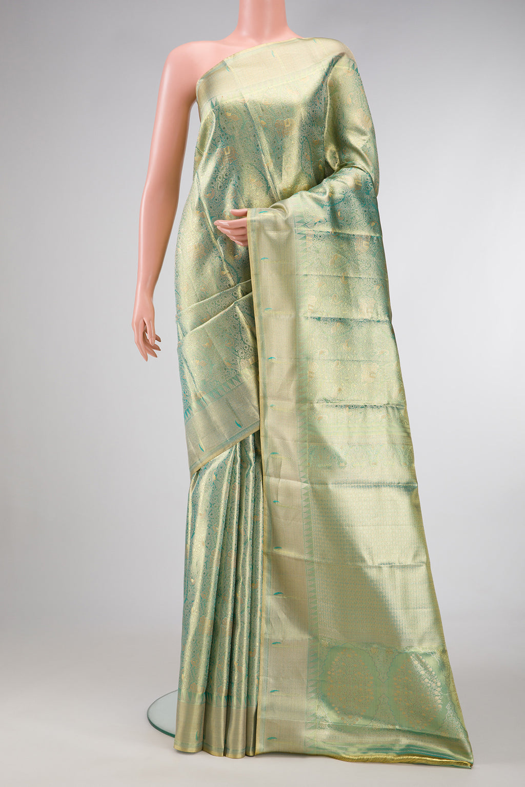 Sea Green Dual Tone Kanjivaram Tissue Silk Saree with Zari Brocade on the body and Zari Border.  displayed on a mannequin