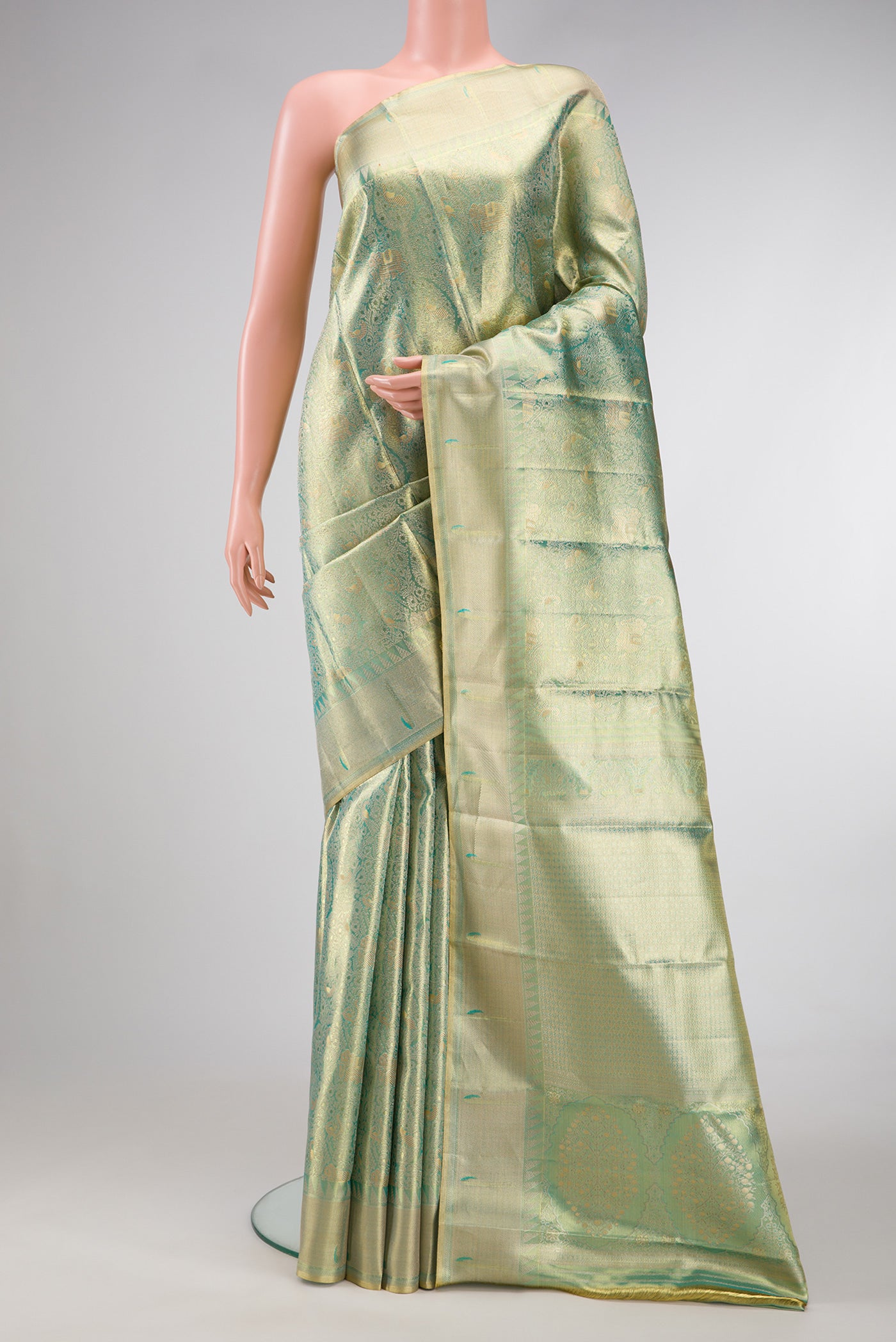 Sea Green Dual Tone Kanjivaram Tissue Silk Saree with Zari Brocade on the body and Zari Border.  displayed on a mannequin