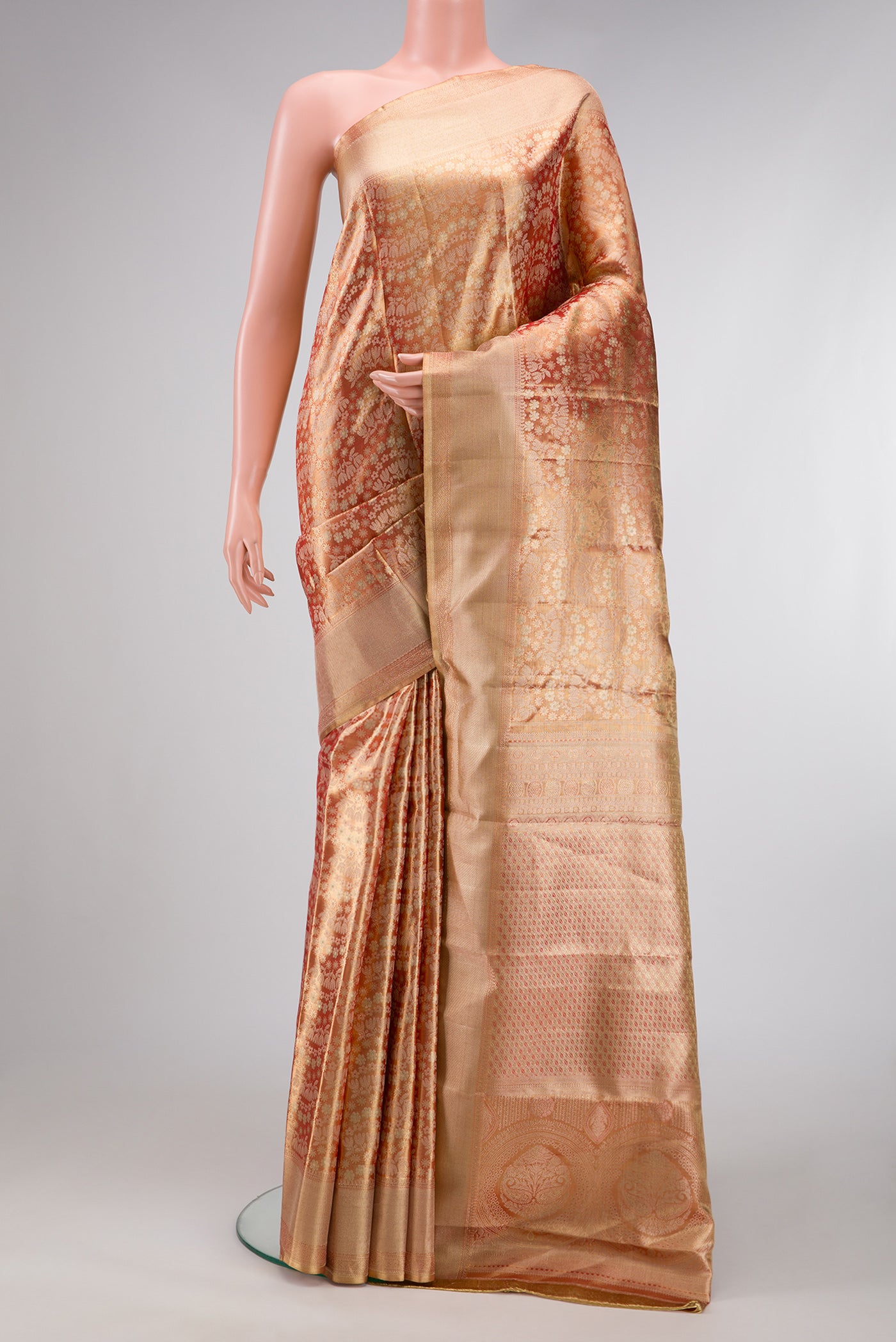 Golden Peach Dual Tone Kanjivaram Tissue Silk Saree with Zari Brocade on the body and Zari Border.  displayed on a mannequin