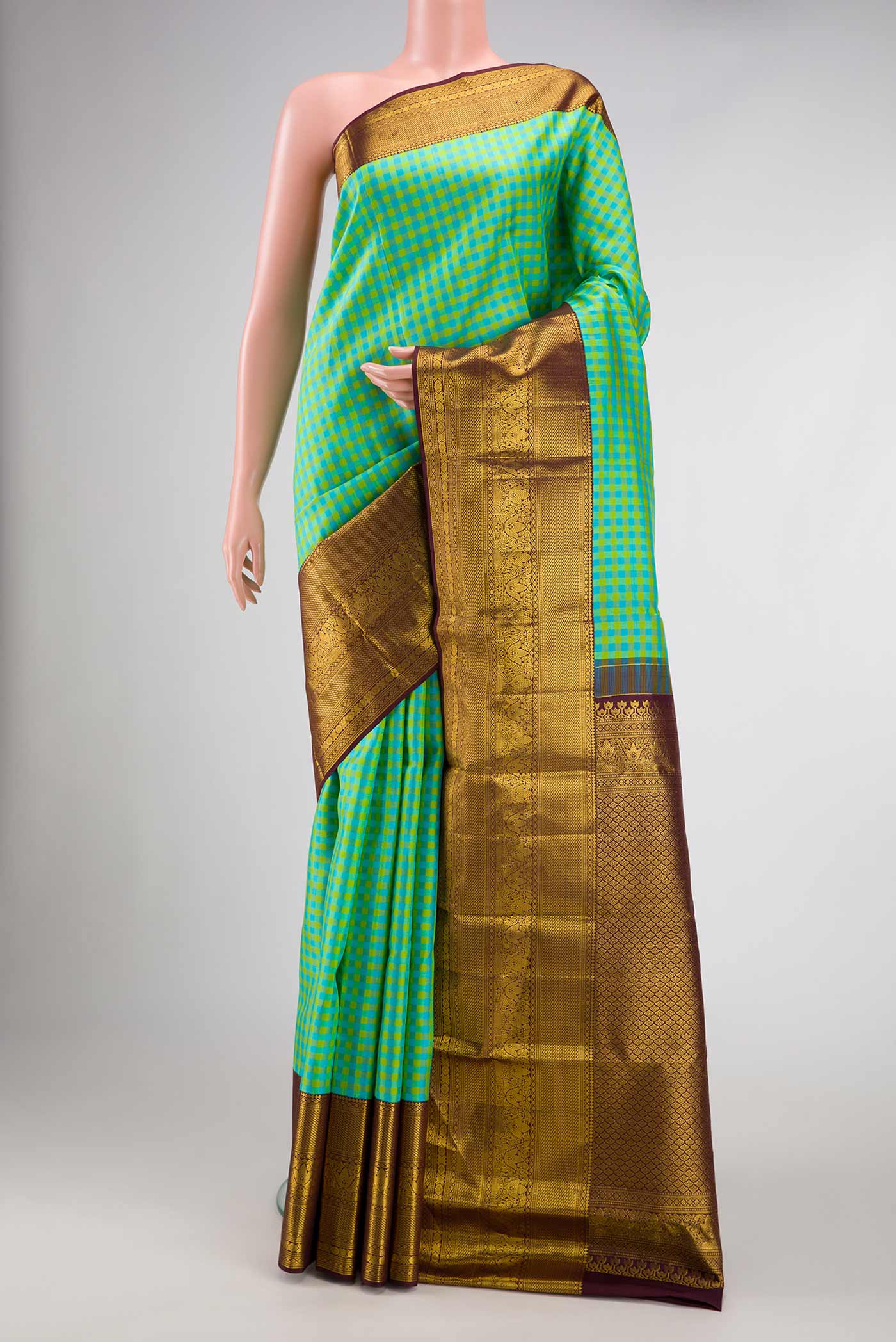Green, Sea Green and Yellow Color Kanjivaram Silk Saree with Checked design on the body and Zari Border.  displayed on a mannequin