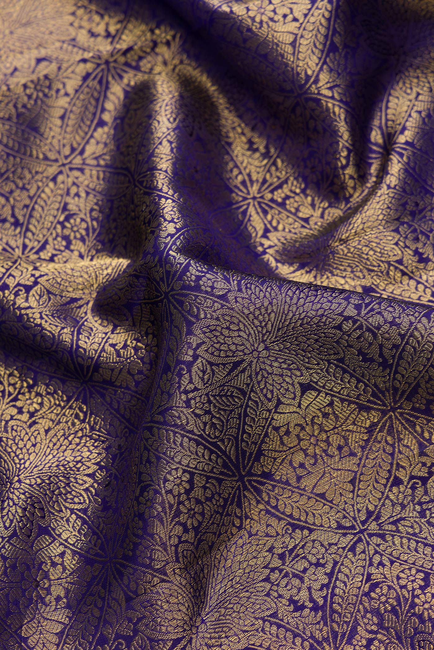 Close up of Navy Blue Dual Tone Kanchipuram Silk Saree with Zari Brocade on the body and Zari Border.  displaying folds