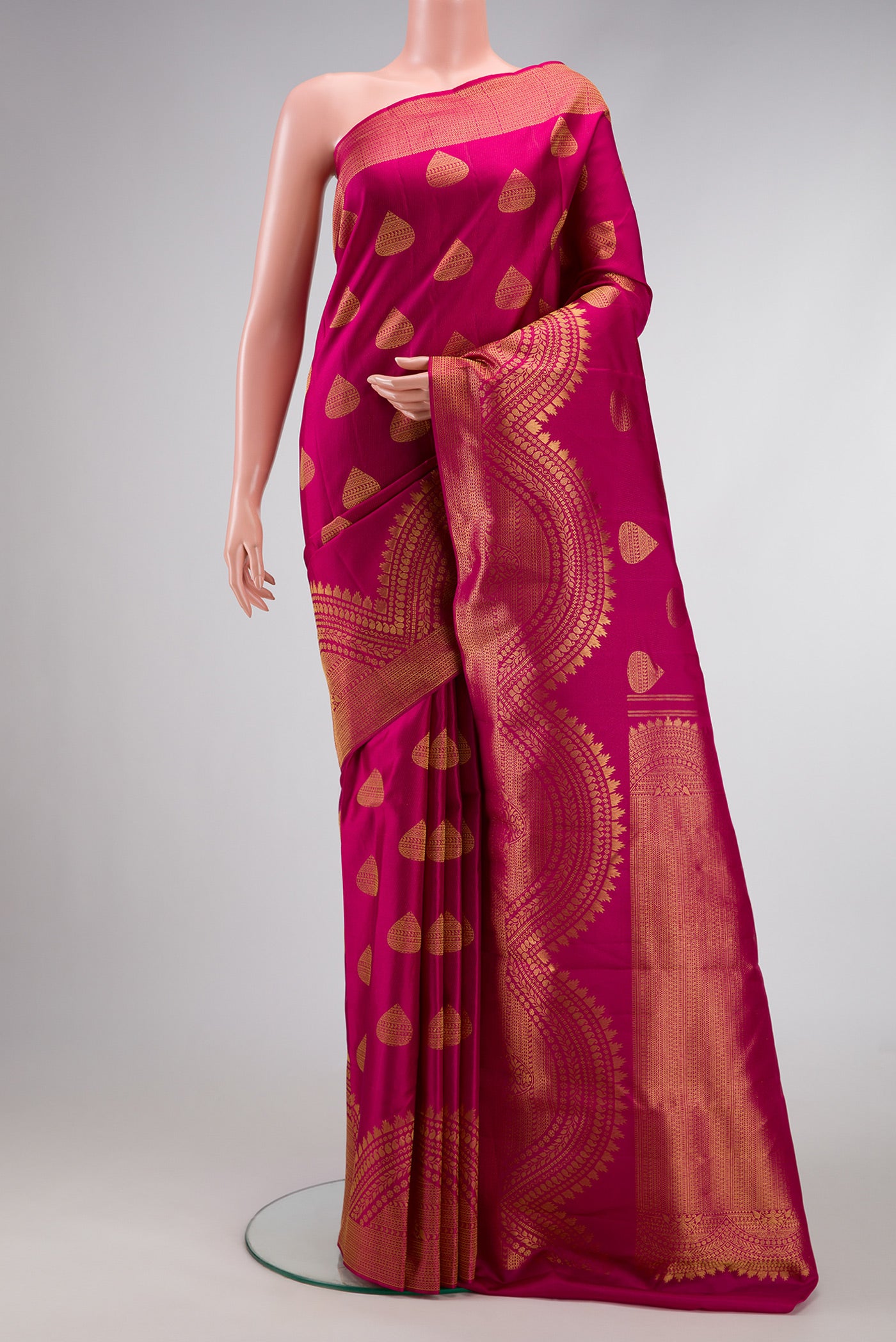 Magenta Dual Tone Kanchipuram Silk Saree with Zari Butta on the body and Fancy Border.  displayed on a mannequin
