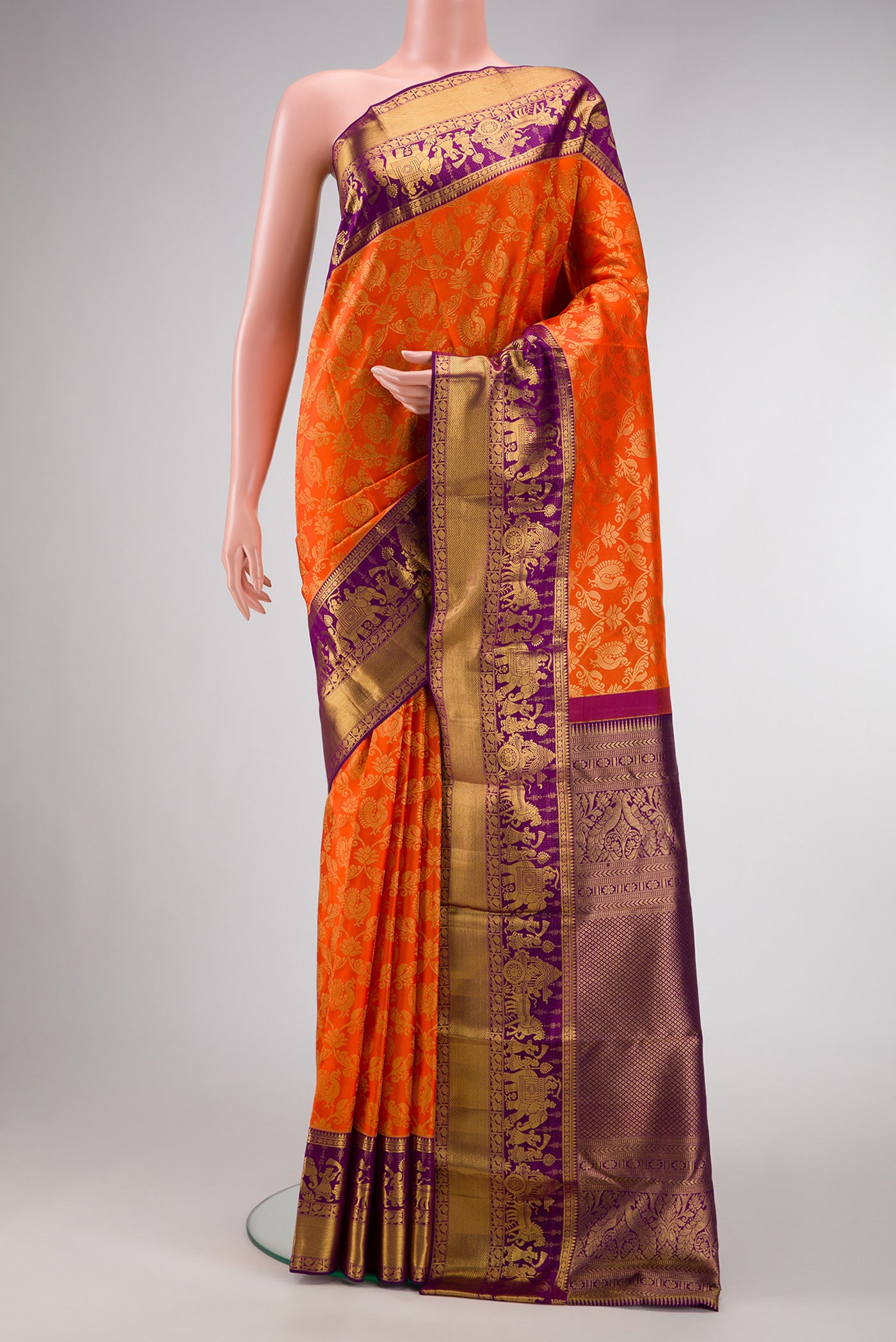 Orange Dual Tone Kanchipuram Silk Saree with Zari Brocade on the body and Zari Border.  displayed on a mannequin