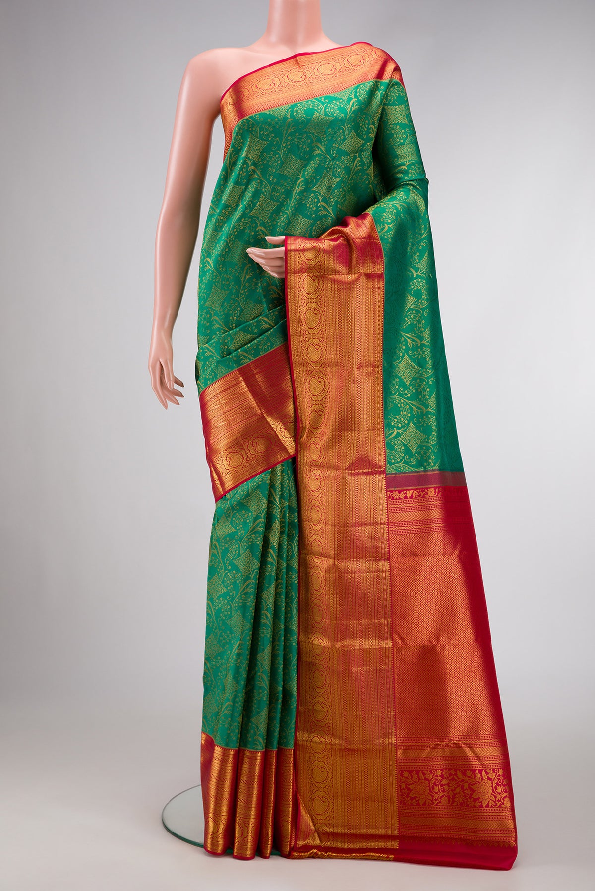 Green Dual Tone Kanchipuram Silk Saree with Zari Brocade on the body and Zari Border.  displayed on a mannequin