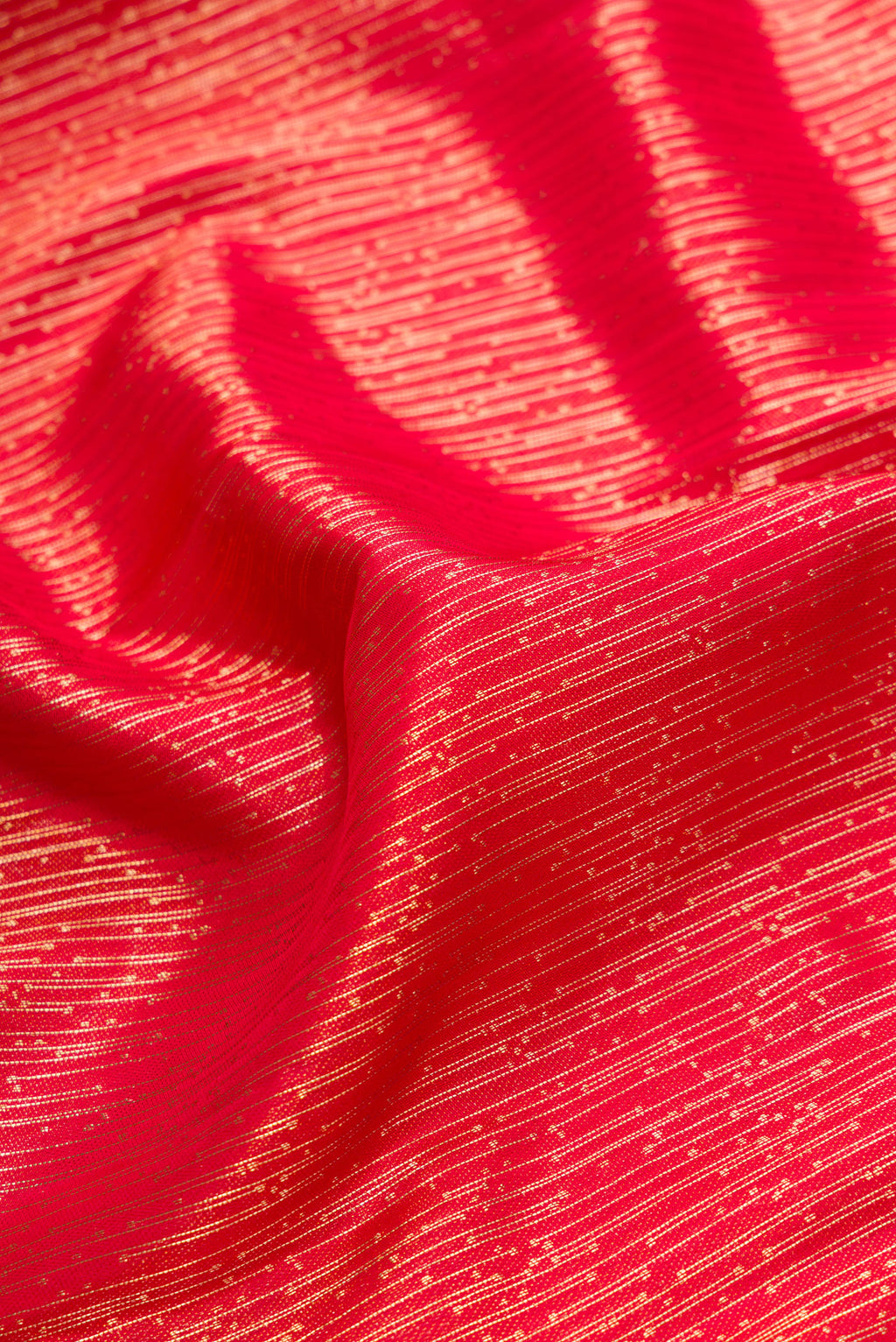 Close up of Red Dual Tone Kanjivaram Silk Saree with Zari Brocade on the body and Fancy Border.  displaying folds