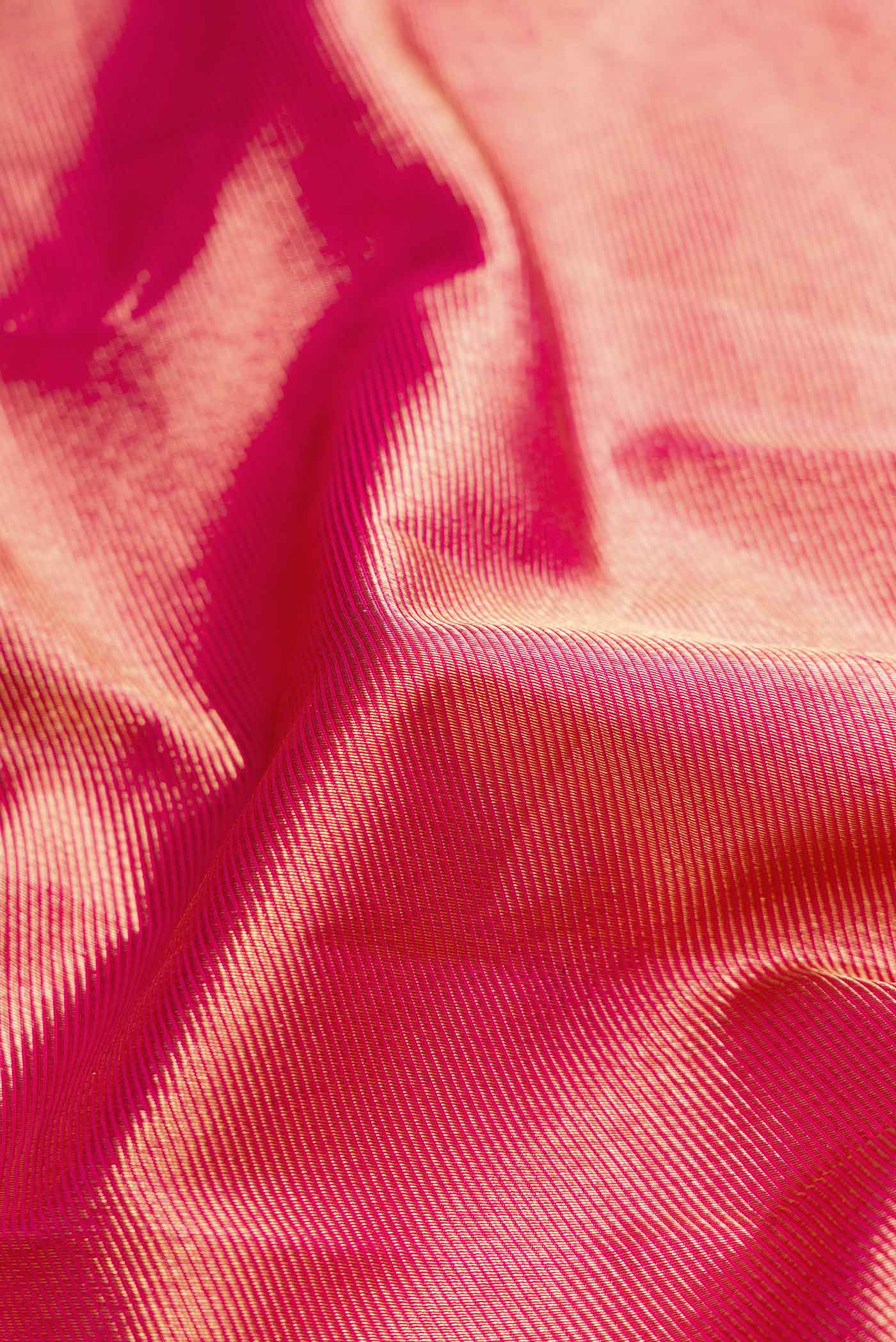 Close up of Pink Dual Tone Kanchipuram Silk Saree with Zari Brocade on the body and Fancy Border displaying folds