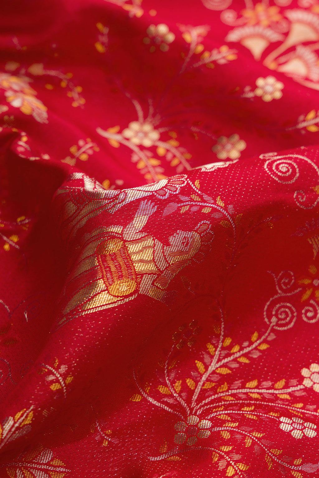 Close up of Red Dual Tone Kanjivaram Silk Saree with Zari Brocade on the body and Zari Border.  displaying folds