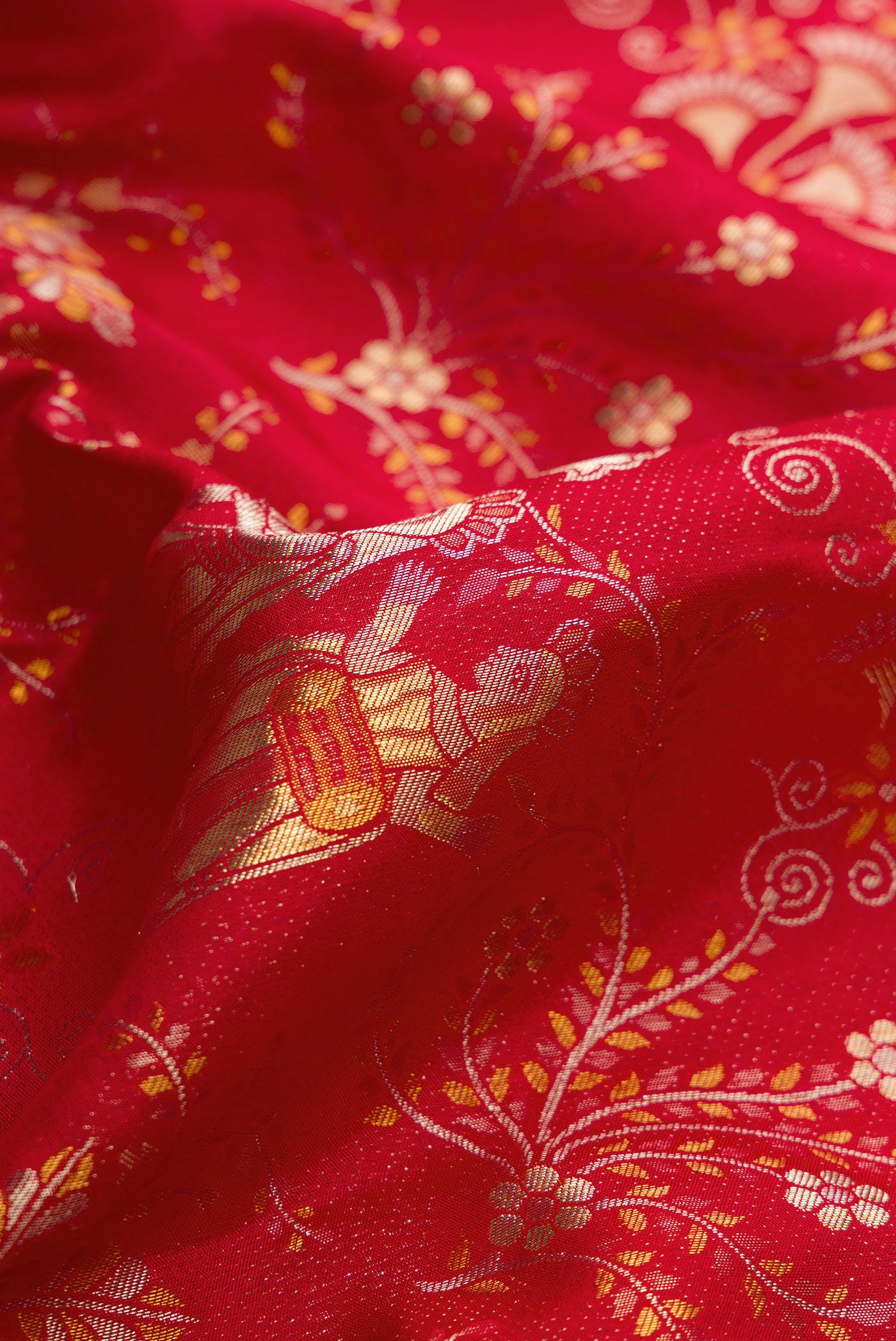Close up of Red Dual Tone Kanjivaram Silk Saree with Zari Brocade on the body and Zari Border.  displaying folds