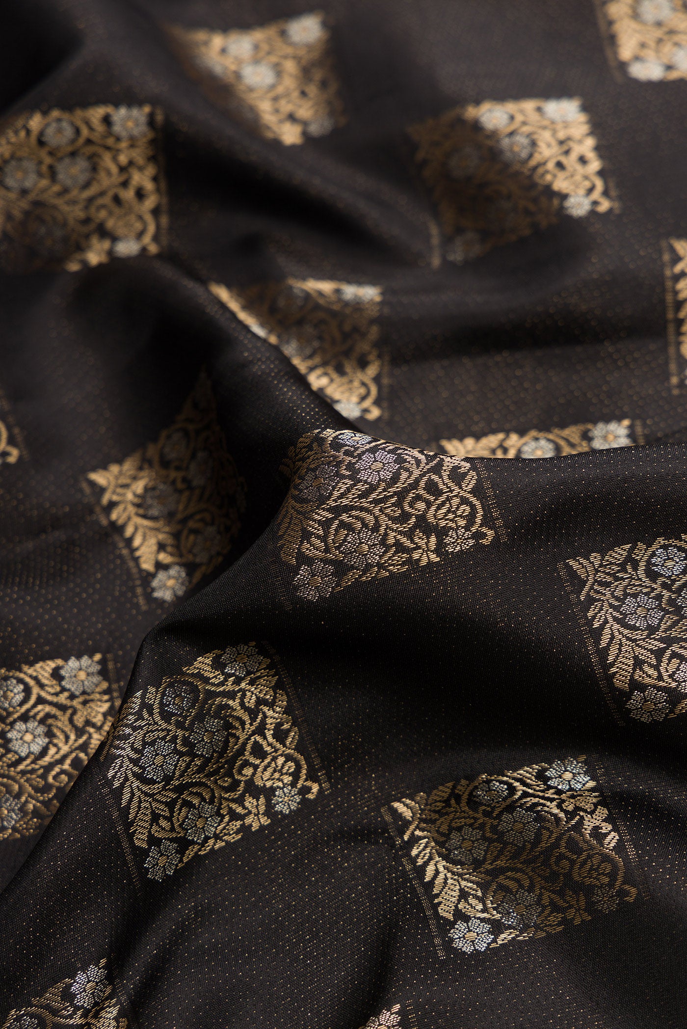 Close up of Black Dual Tone Kanjivaram Silk Saree with Zari Brocade on the body and Fancy Border.  displaying folds