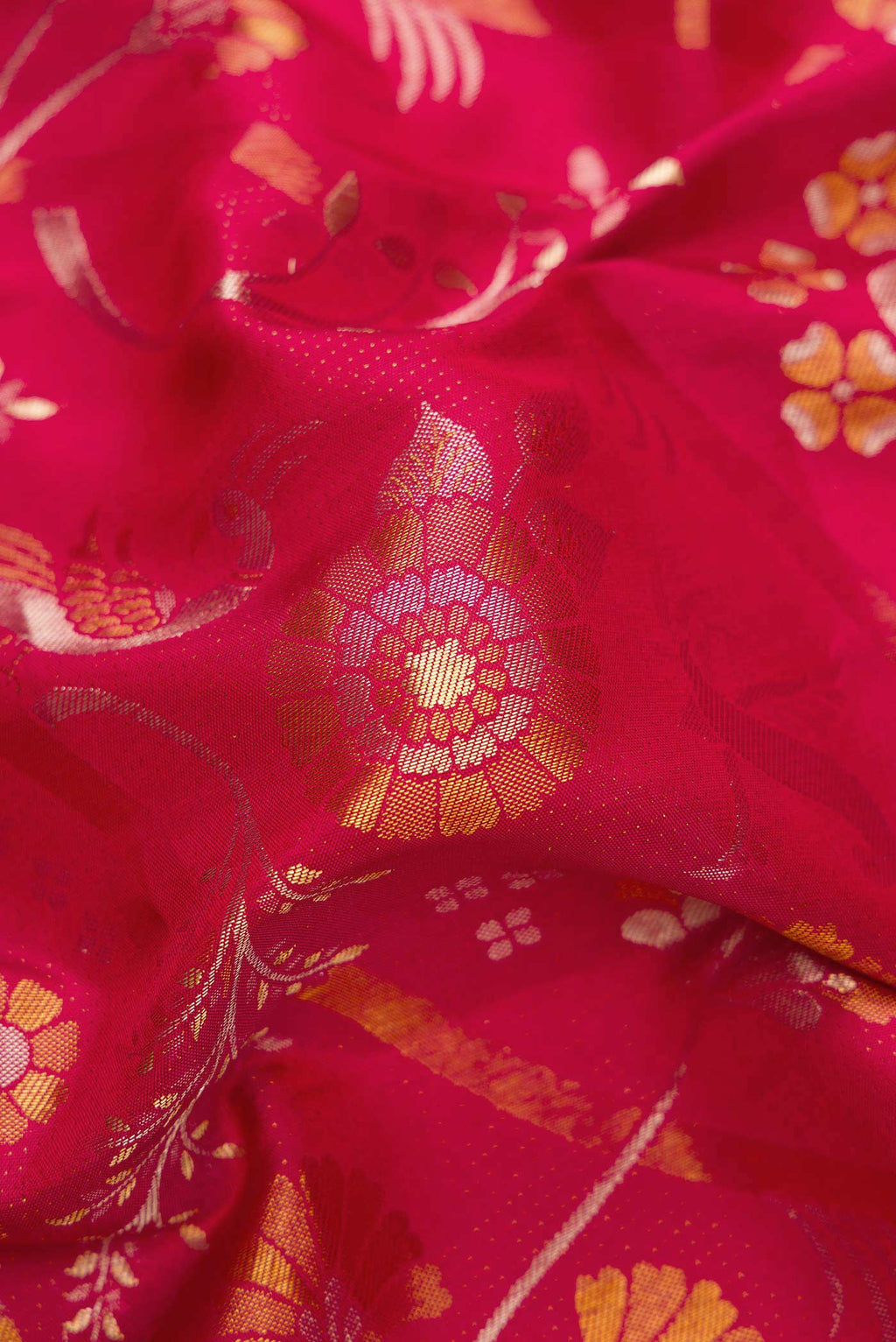 Close up of Red Dual Tone Kanjivaram Silk Saree with Zari Brocade on the body and Zari Border.  displaying folds