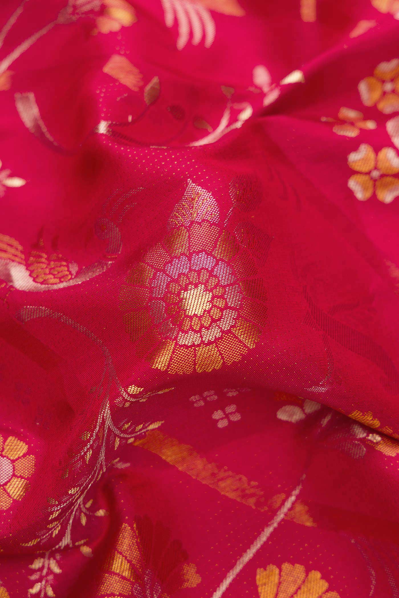 Close up of Red Dual Tone Kanjivaram Silk Saree with Zari Brocade on the body and Zari Border.  displaying folds