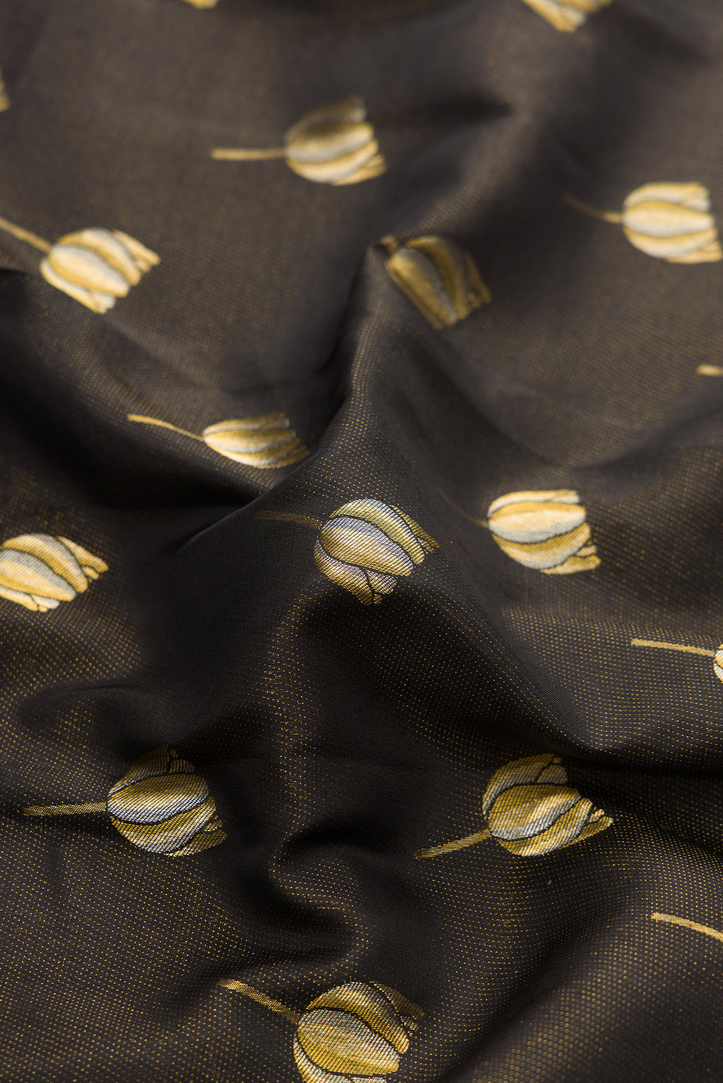 Close up of Black Dual Tone Kanjivaram Silk Saree with Zari Butta on the body and Fancy Border.  displaying folds