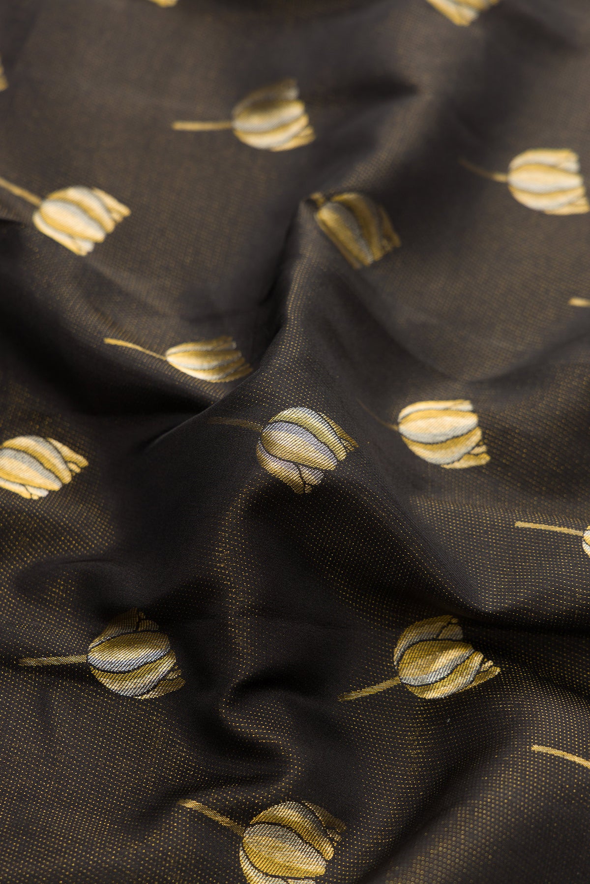 Close up of Black Dual Tone Kanjivaram Silk Saree with Zari Butta on the body and Fancy Border.  displaying folds