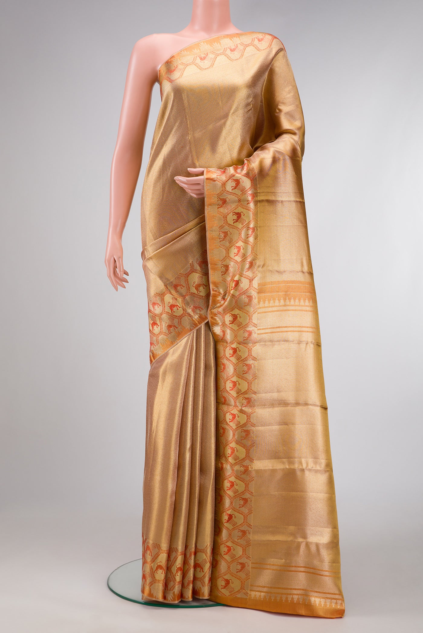 Gold Dual Tone Kanchipuram Tissue Silk Saree with Zari Brocade on the body and Fancy Border.  displayed on a mannequin