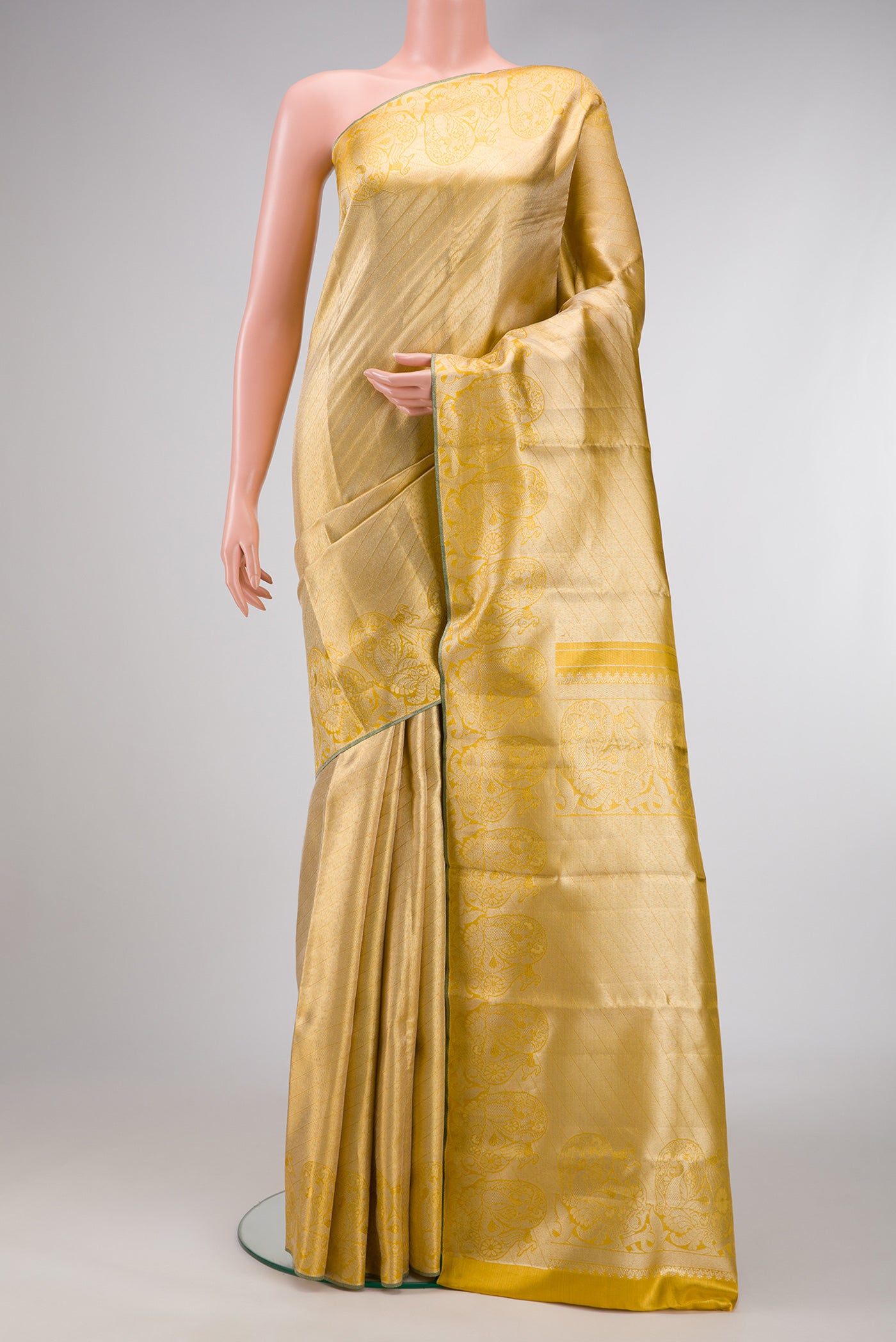 Gold Dual Tone Kanchipuram Tissue Silk Saree with Zari Brocade on the body and Zari Border.  displayed on a mannequin
