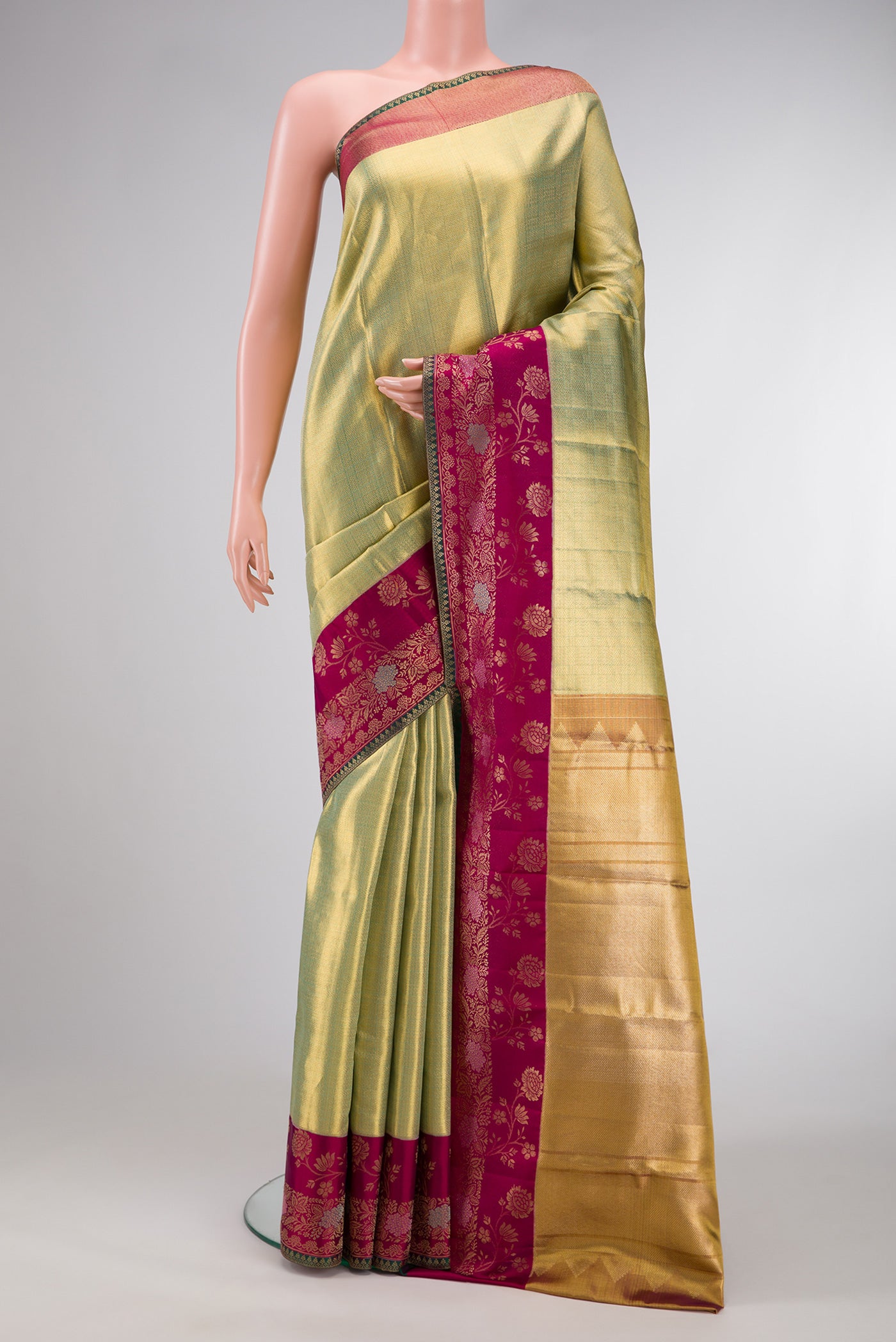 Pista Green Dual Tone Kanjivaram Tissue Silk Saree with Zari Brocade on the body and Fancy Border.  displayed on a mannequin