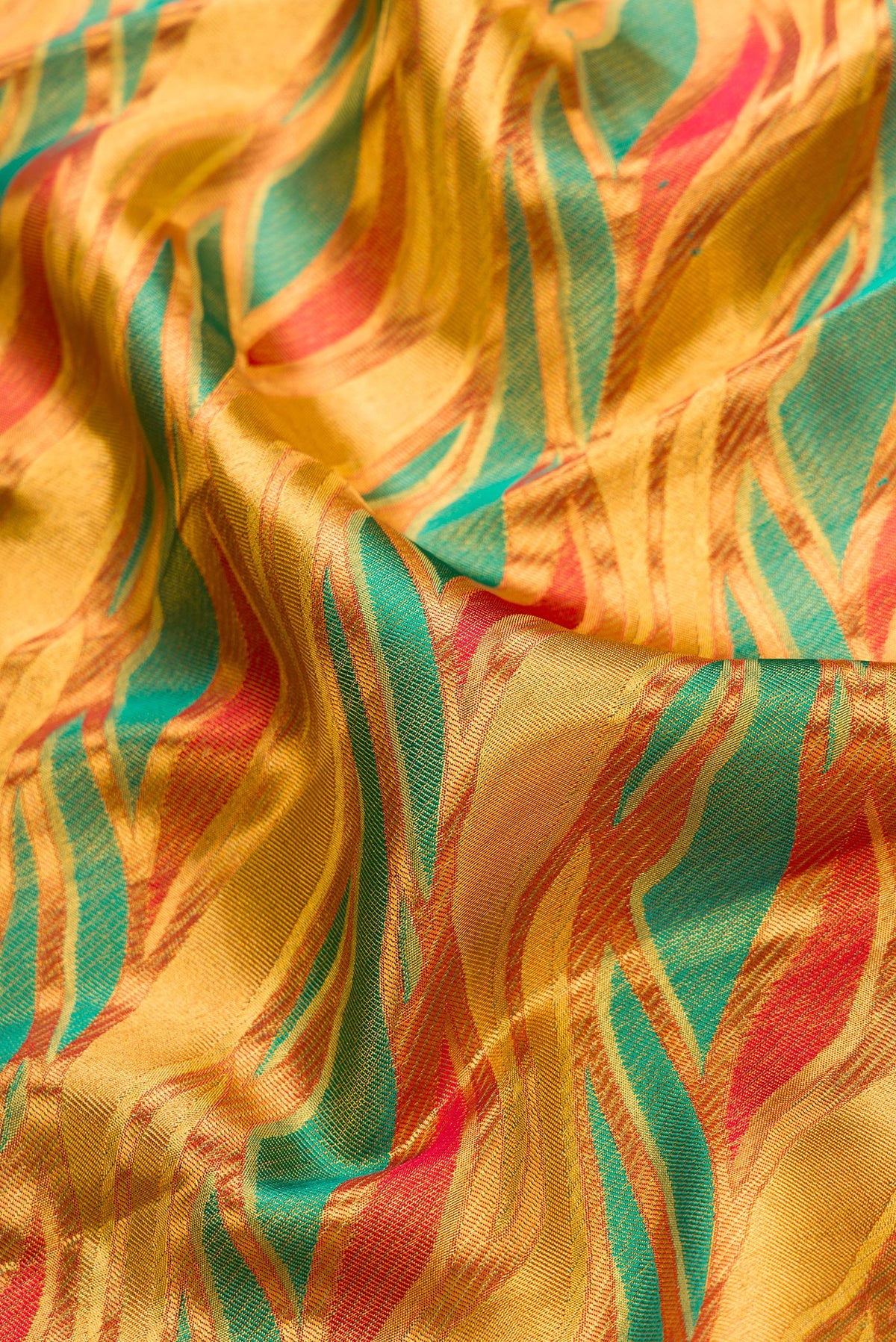 Close up of Gold Dual Tone Kanjivaram Tissue Silk Saree with Zari Brocade on the body and Zari Border.  displaying folds