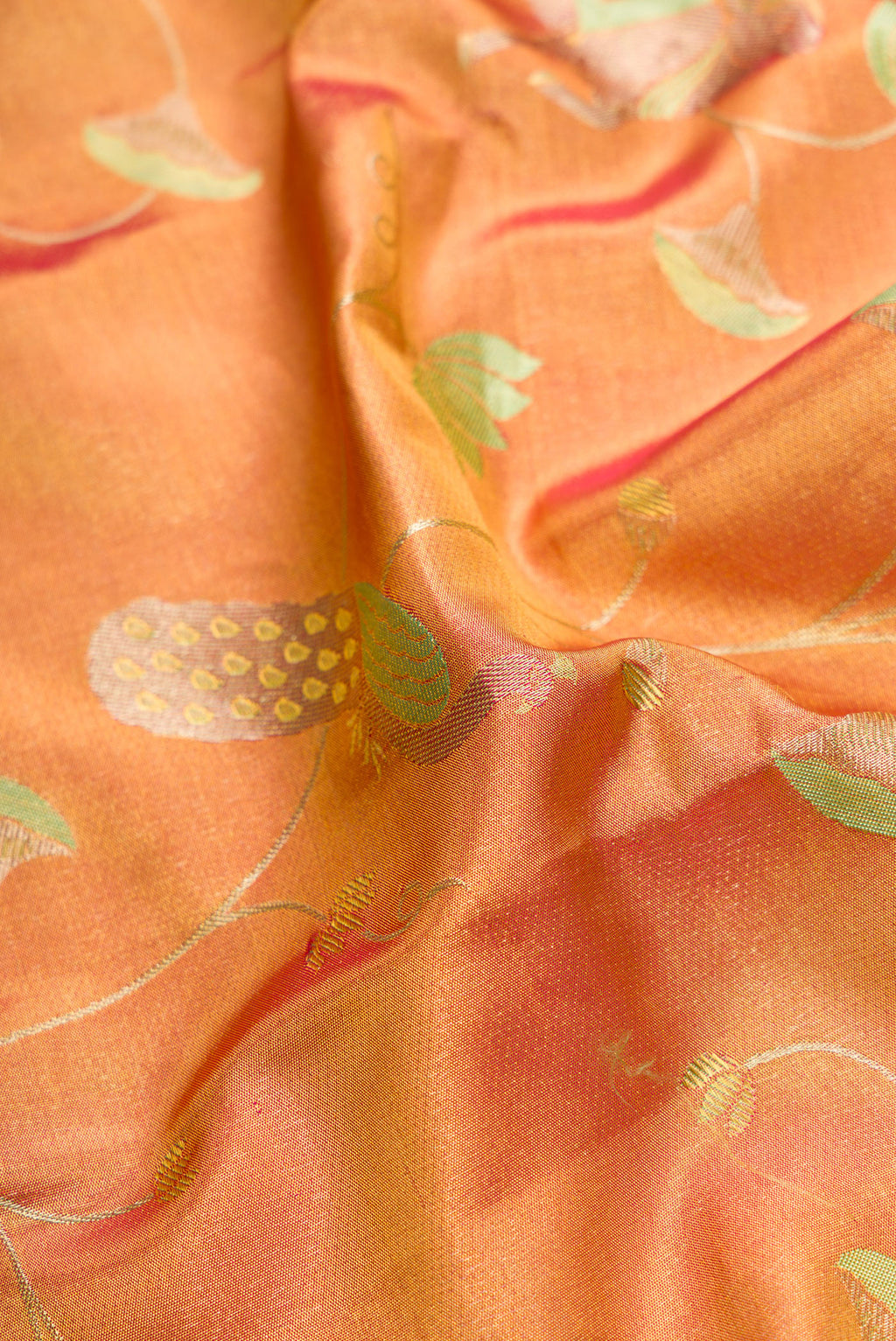Close up of Gold Dual Tone Kanjivaram Tissue Silk Saree with Zari Brocade on the body and Zari Border.  displaying folds