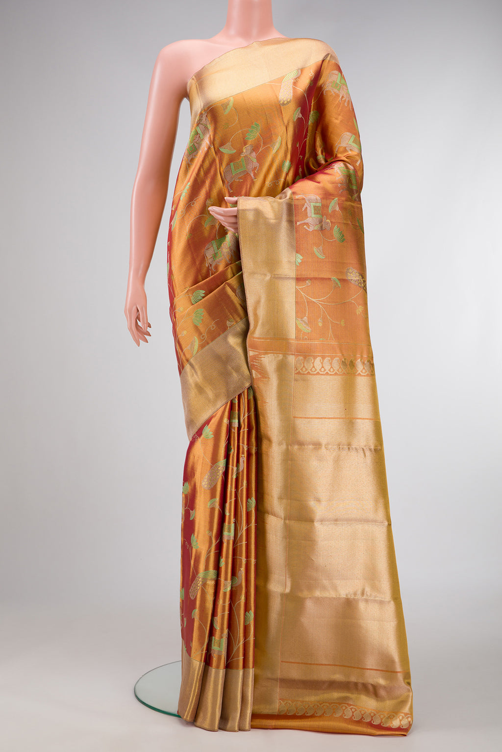 Gold Dual Tone Kanjivaram Tissue Silk Saree with Zari Brocade on the body and Zari Border.  displayed on a mannequin