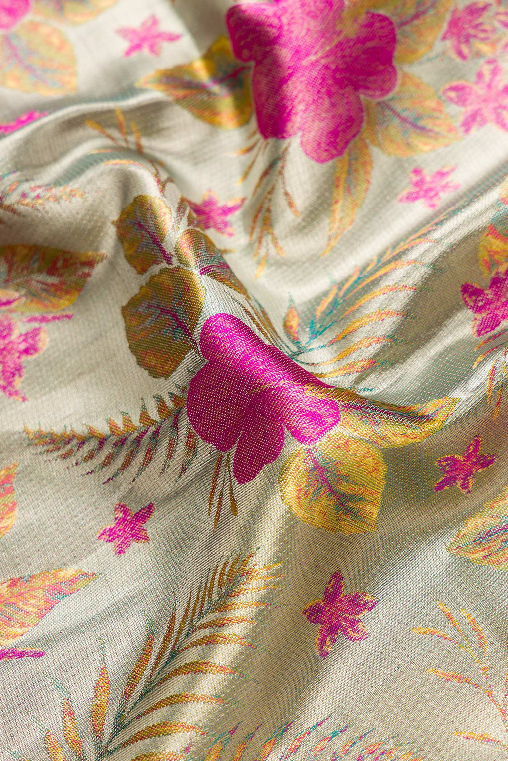 Close up of Green Dual Tone Kanjivaram Tissue Silk Saree with Zari Brocade on the body and Zari Border.  displaying folds