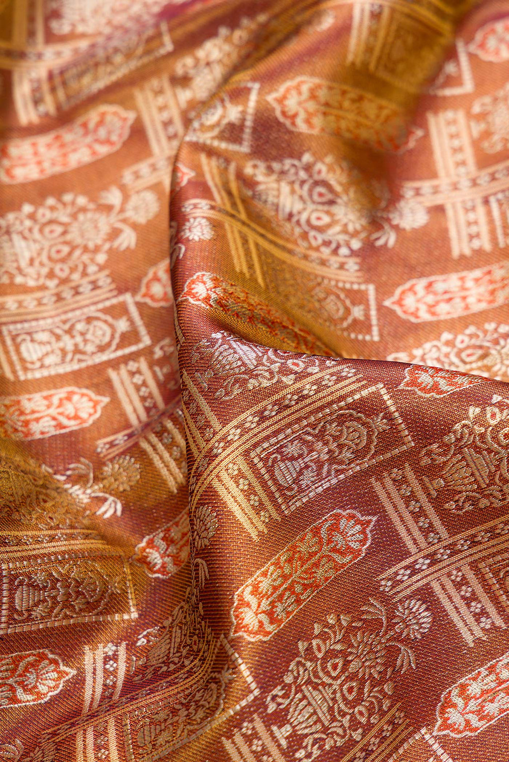 Close up of Brown Dual Tone Kanjivaram Tissue Silk Saree with Zari Brocade on the body and Fancy Border.  displaying folds