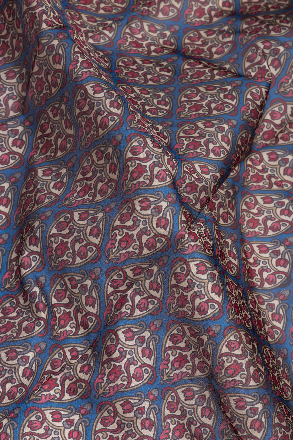 Close up of Blue Printed Silk Saree with Printed design on the body and Printed Border.  displaying folds