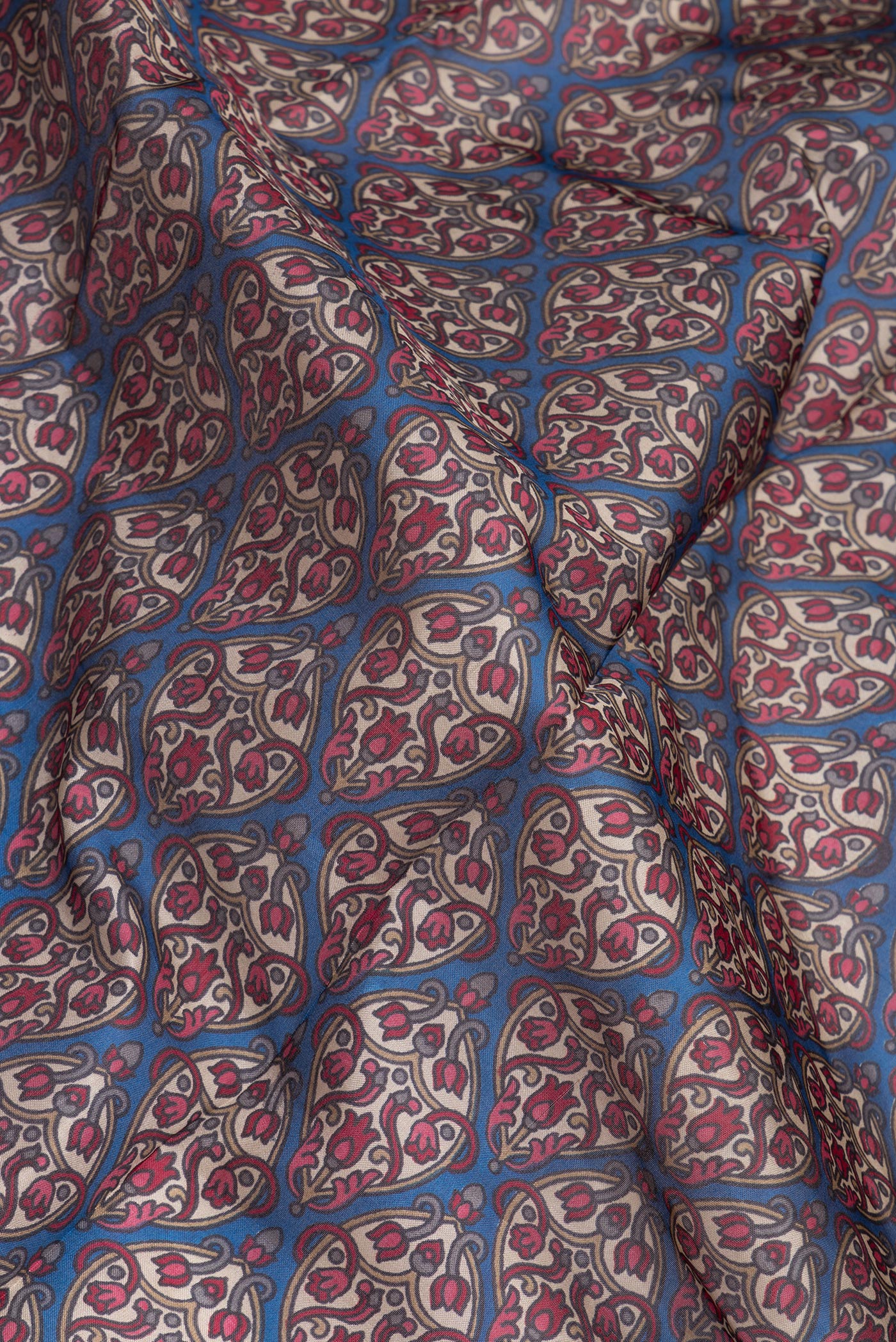 Close up of Blue Printed Silk Saree with Printed design on the body and Printed Border.  displaying folds