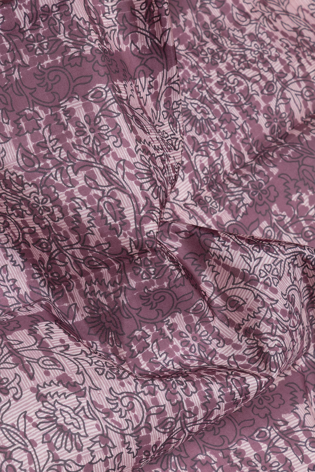 Close up of Purple Printed Silk Saree with Printed design on the body and Printed Border.  displaying folds