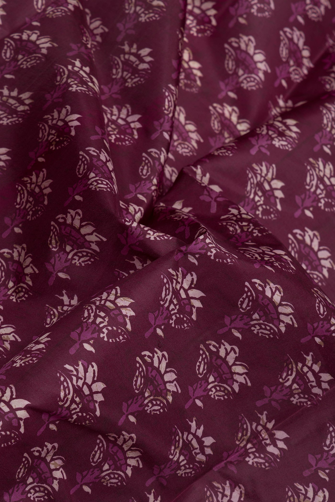Close up of Purple Printed Silk Saree with Printed design on the body and Printed Border.  displaying folds